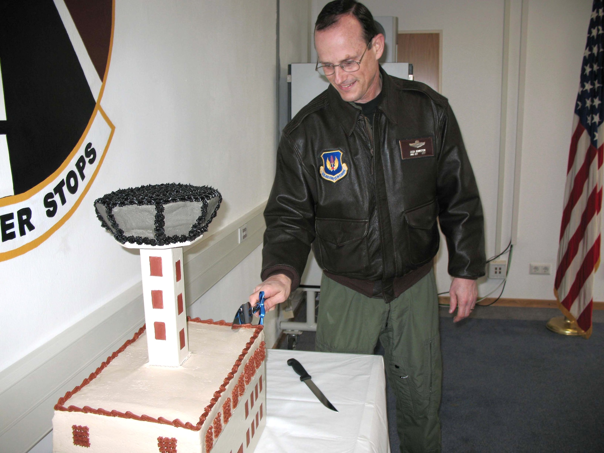 Brig. Gen. Richard Johnston cuts a tower of a cake March 13 in celebration of the new tower cab that opened at Ramstein Air Base, Germany.  General Johnston is the 86th Airlift Wing commander. (U.S. Air Force photo/Staff Sgt. Jason David)