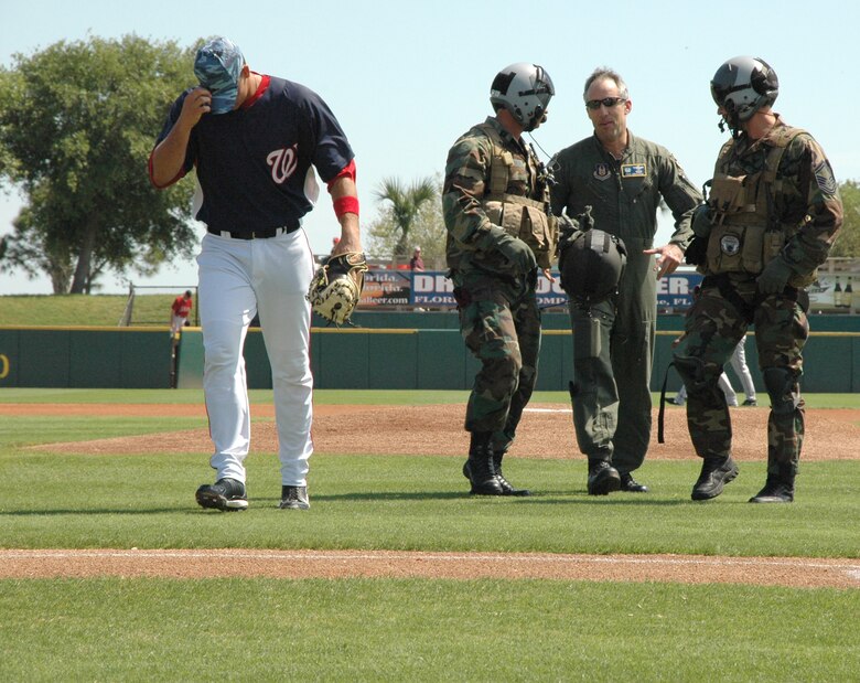 Baseball fans cheered and expressed their appreciation as the 920th Rescue Wing opened a March 8 Washington Nationals Spring Training Game by landing on the field and dropping off the wing commander, Col. Steve Kirkpatrick escorted by two pararescuemen, to throw out the first pitch.  After the pitch, Col. Kirkpatrick and the two PJs were greeted by the pitcher then walked off the field to a flurry a "military fans" who cheered them on.
