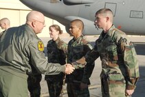 MINOT AIR FORCE BASE, N.D. -- Air Force Chief of Staff Gen. T. Michael Moseley shakes hands with Airman 1st Class Craig McNett, 5th Aircraft Maintenance Squadron. General Moseley and his wife, Jennie, visited the base March 14. While here, they toured both the 5th Bomb Wing and 91st Space Wing. (U.S. Air Force photo by Senior Airman Stacy Moless)