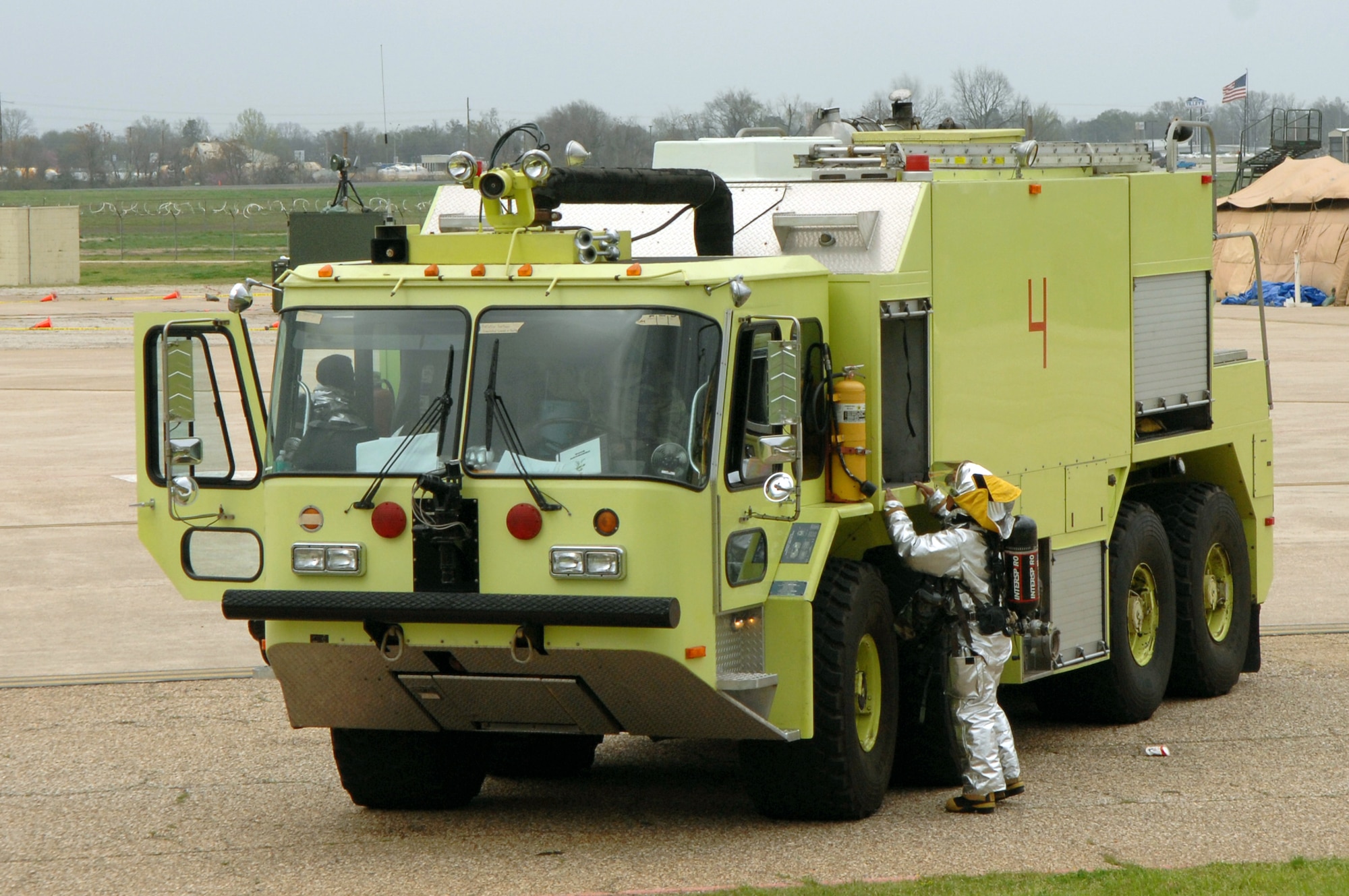 Airman Michael Ramos grabs a tool from a storage compartment on the outside of a fire truck Feb. 12 during a Conventional Operational Readiness Exercise at Barksdale Air Force, La. Airman Ramos is working in support of Global Cajun 07-2 exercise. (U.S. Air Force photo/Airman 1st Class Joanna Kresge)