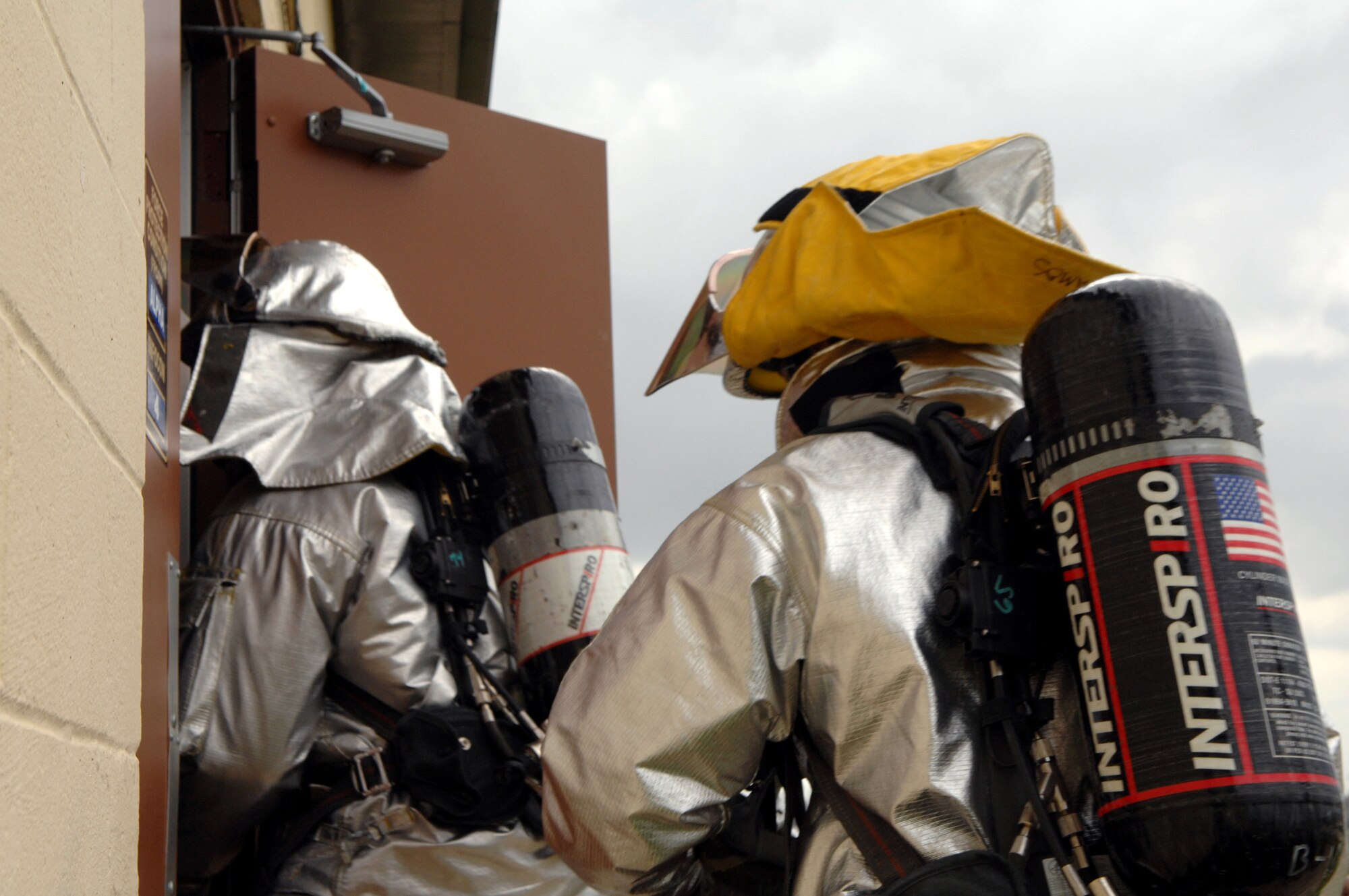 Staff Sergeant Roderick Wiggins (left) and Airman Michael Ramos rush to put out a mock electrical fire as part of a Conventional Operational Readiness Exercise March 12 at Barksdale Air Force Base, La. The Airmen are working in support of Global Cajun 07-2. (U.S. Air Force photo/Airman 1st Class Joanna Kresge)