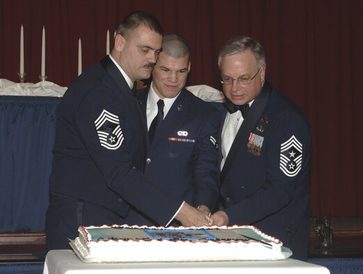 FAIRCHILD AIR FORCE BASE, Wash. -- Chief Master Sgt. Jon Stuhr, 66th Training Squadron, Airman 1st Class Luis Arteaga, 92nd Services Squadron, and Chief Master Sgt. Craig Weddle, 141st Air Refueling Wing command chief, cut the cake. (U.S. Air Force photo/Senior Airman Chad Watkins)
