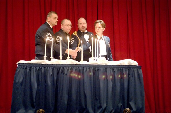 FAIRCHILD AIR FORCE BASE, Wash. -- Chief Master Sgt. Jon Stuhr, 66th Training Squadron, Senior Master Sgt. Chris Williams, 92nd Maintenance Operations Squadron, Senior Master Sgt. Brian Lavoie, 92nd Operations Support Squadron, and Chief Master Sgt. Judith Ruiz, 92nd Air Refueling Wing interim command chief, light the ceremonial candles. (U.S. Air Force photo/Senior Airman Chad Watkins)
