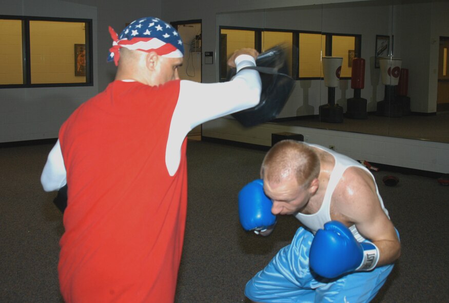 Corando Flores, Jr., national kickboxing champion, instructs Jeff Langham, former Dyess B-1 crew chief, in how to duck and dodge a jab at the fitness center March 13. Classes are offered Tuesdays and Thursdays at 7 p.m. (U.S. Air Force photo by Airman 1st Class Carolyn Viss)