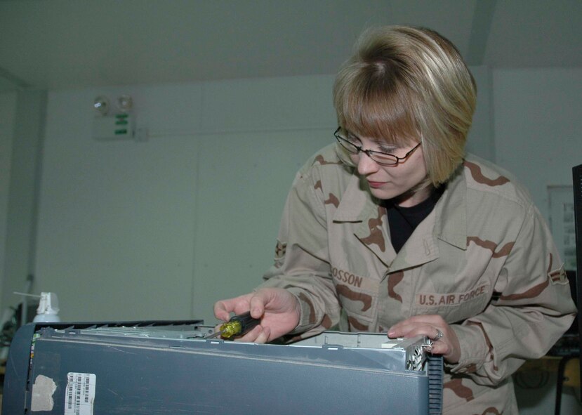 KIRKUK REGIONAL AIR BASE, Iraq -- Airman 1st Class Emily Cosson, 506th Expeditionary Communications Squadron client support administrator, repairs a computer Feb. 21. Airman Cosson maintains and troubleshoots all Air Force and Army computers at Kirkuk. (U.S. Air Force photo/ Tech. Sgt. Kevin Williams)