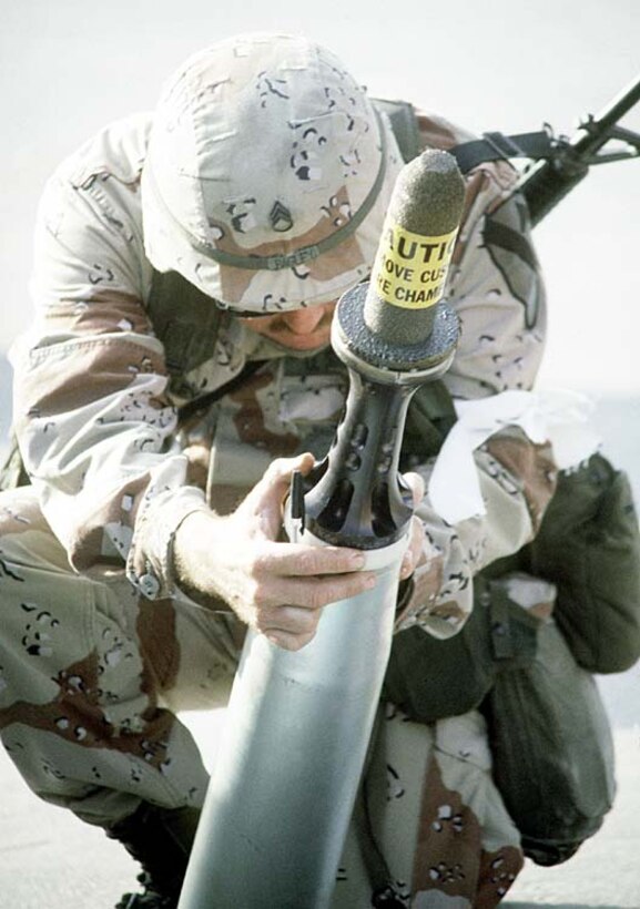 An ammunition specialist examines a 105mm armor-piercing round to be used in an M-1 Abrams main battle tank during Operation Desert Shield in 1991. The object on the nose of the round is a sabot, a cover that protects and stabilizes the round's needle-like depleted uranium penetrator, then falls away as the projectile leaves the gun barrel. DoD Photo