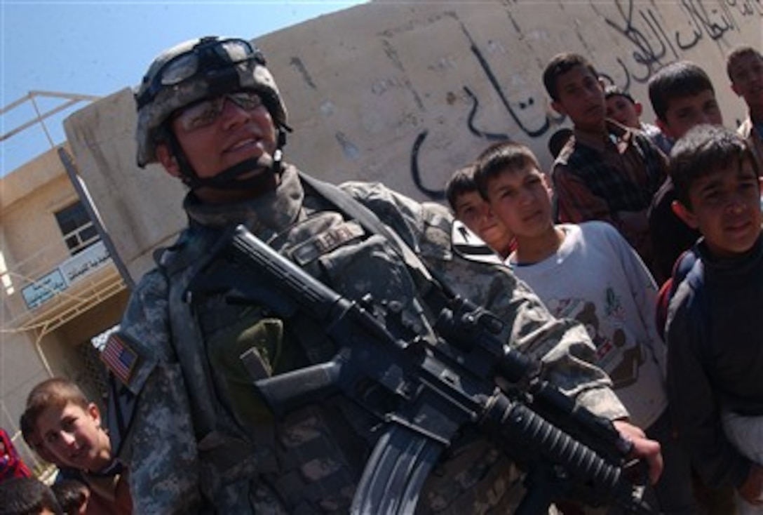 U.S. Army Staff Sgt. Jason Elemen, from Delta  Company, 2nd Battalion, 7th Cavalry Regiment, 4th Brigade Combat Team, 1st Cavalry Division, out of Fort Bliss, Texas, provides security outside a school in Mosul, Iraq, March 7, 2007.            
     
