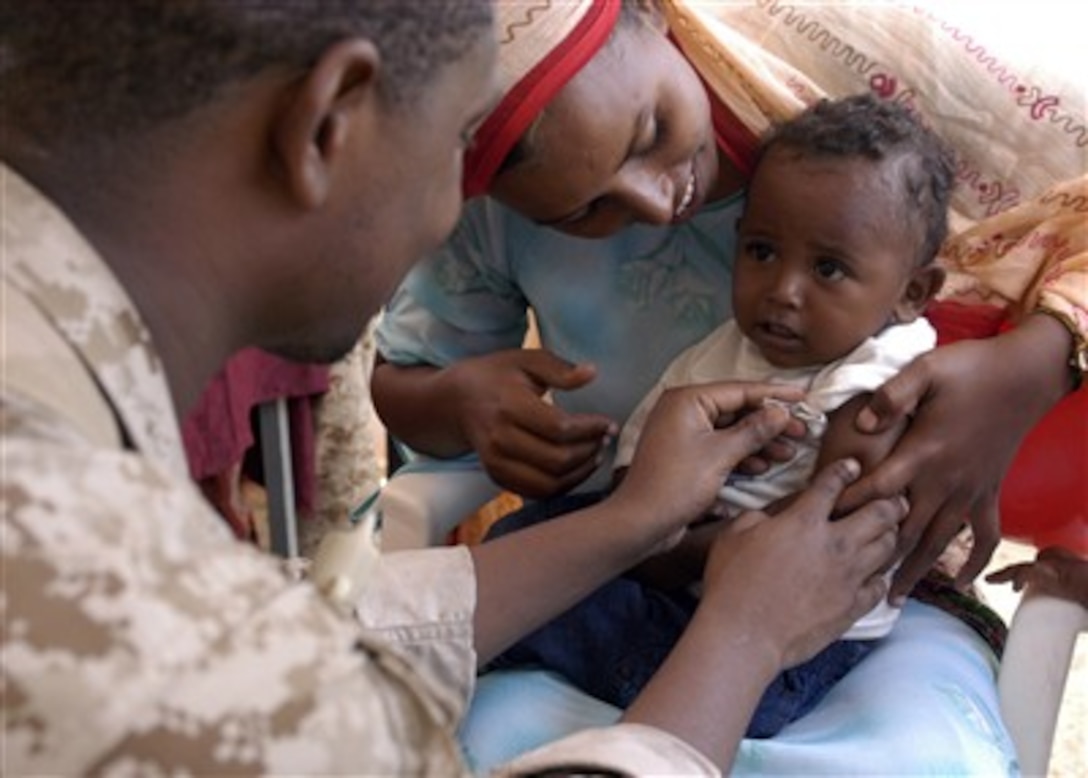 Petty Officer 3rd Class Kenneth Russell takes the temperature of a child during a medical civil assistance project at Barigoni School in Barigoni, Kenya, on March 7, 2007. The medical project was part of bilateral exercise Edged Mallet 2007, a U.S. and Kenyan military exercise designed to enhance interoperability and tactical proficiency of both nations, while providing practical training for medical specialists.  Russell is a U.S. Navy hospital corpsman.  