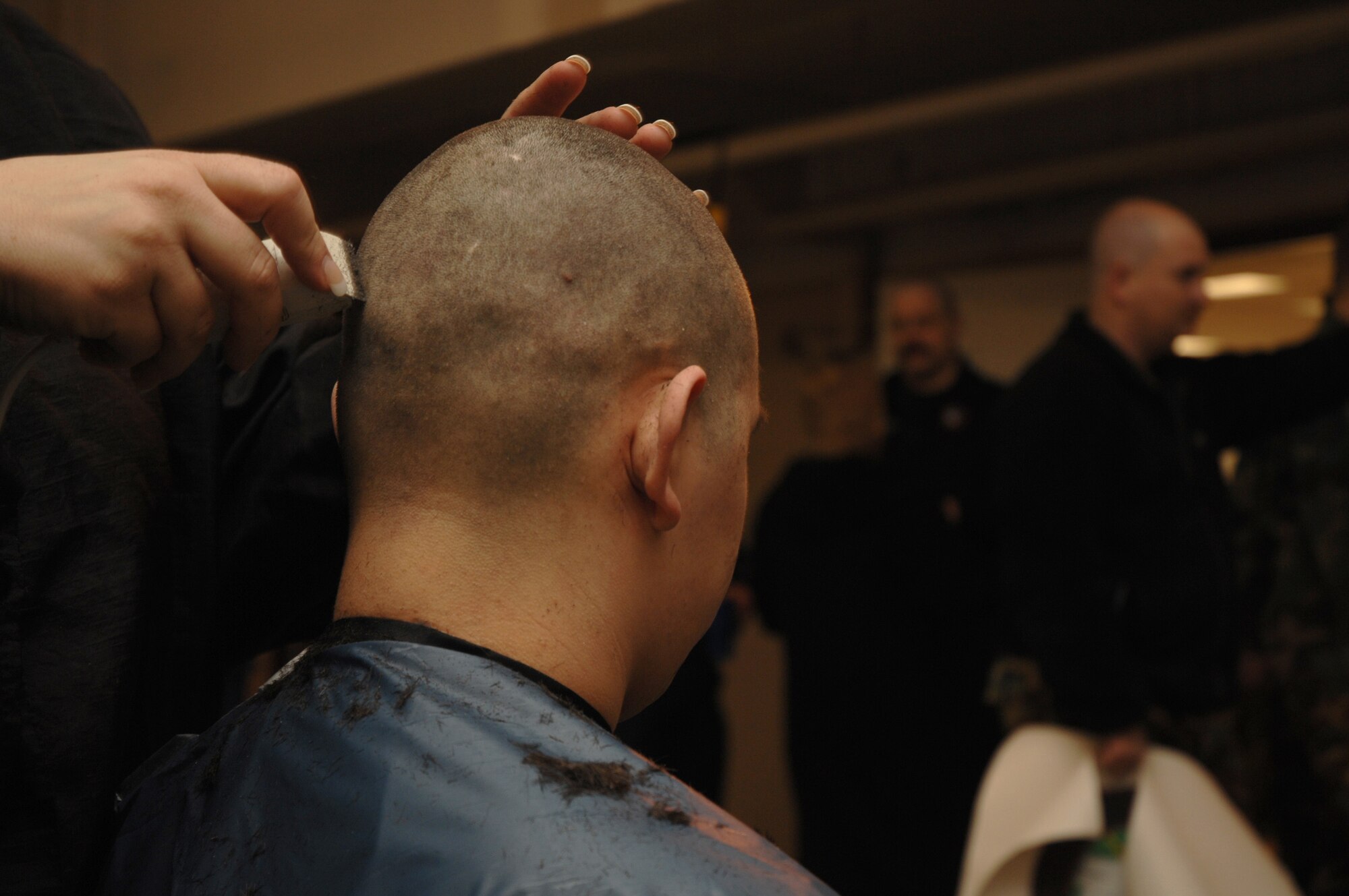 EIELSON AIR FORCE BASE, Alaska -- Airman 1st Class Dax Chacon, 354th Civil Engineer Squadron fire fighter, gets his head shaved on March 15 at Fire Station #1 while other fire fighters watch. Members of the Eielson Fire Fighter Association shaved their heads to raise money for St. Baldricks Foundation which $5 million so far this year for childrens cancer research.
(U.S. Air Force Photo by Staff Sgt Joshua Strang)
