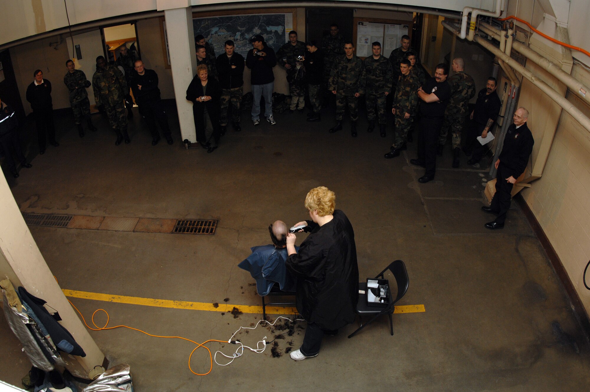 EIELSON AIR FORCE BASE, Alaska -- Mr. Jeff Akin, Fire Fighter, 354th Civil Engineer Squadron, gets his head shaved on March 15 at Fire Station #1 by Mrs. Sammantha Tippets wife of fire fighter SSgt Stephen Tippets. Members of the Eielson Fire Fighter Association shaved their heads to raise money for St. Baldricks Foundation which raises funds for childrens cancer research. More than 11,000 male and more than 1,000 female shavees support the 2007 fundraiser.
(U.S. Air Force Photo by Staff Sgt Joshua Strang)