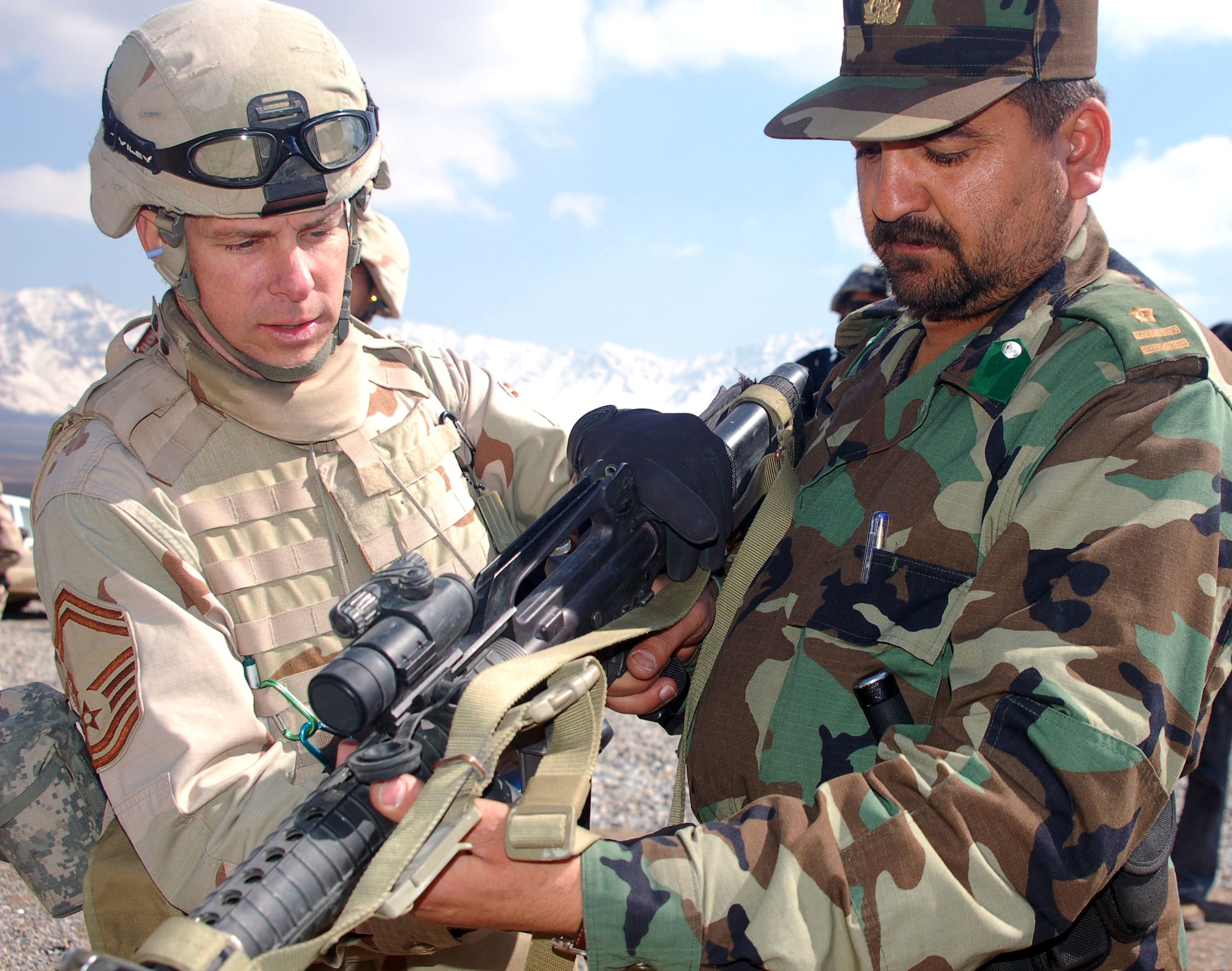 Senior Master Sgt. Robert Spaulding shows Afghan National Army Capt. Abdul Rahman the mechanics of an M-16 March 14.  Captain Rahman is 1st Company military police commander.  Sergeant Spaulding, the garrison sergeant major for the Training Assistance Group, is deployed from the 4th Logistics Readiness Squadron at Seymour-Johnson Air Force Base, N.C.  (U.S. Air Force photo/Senior Airman Stacia Zachary)