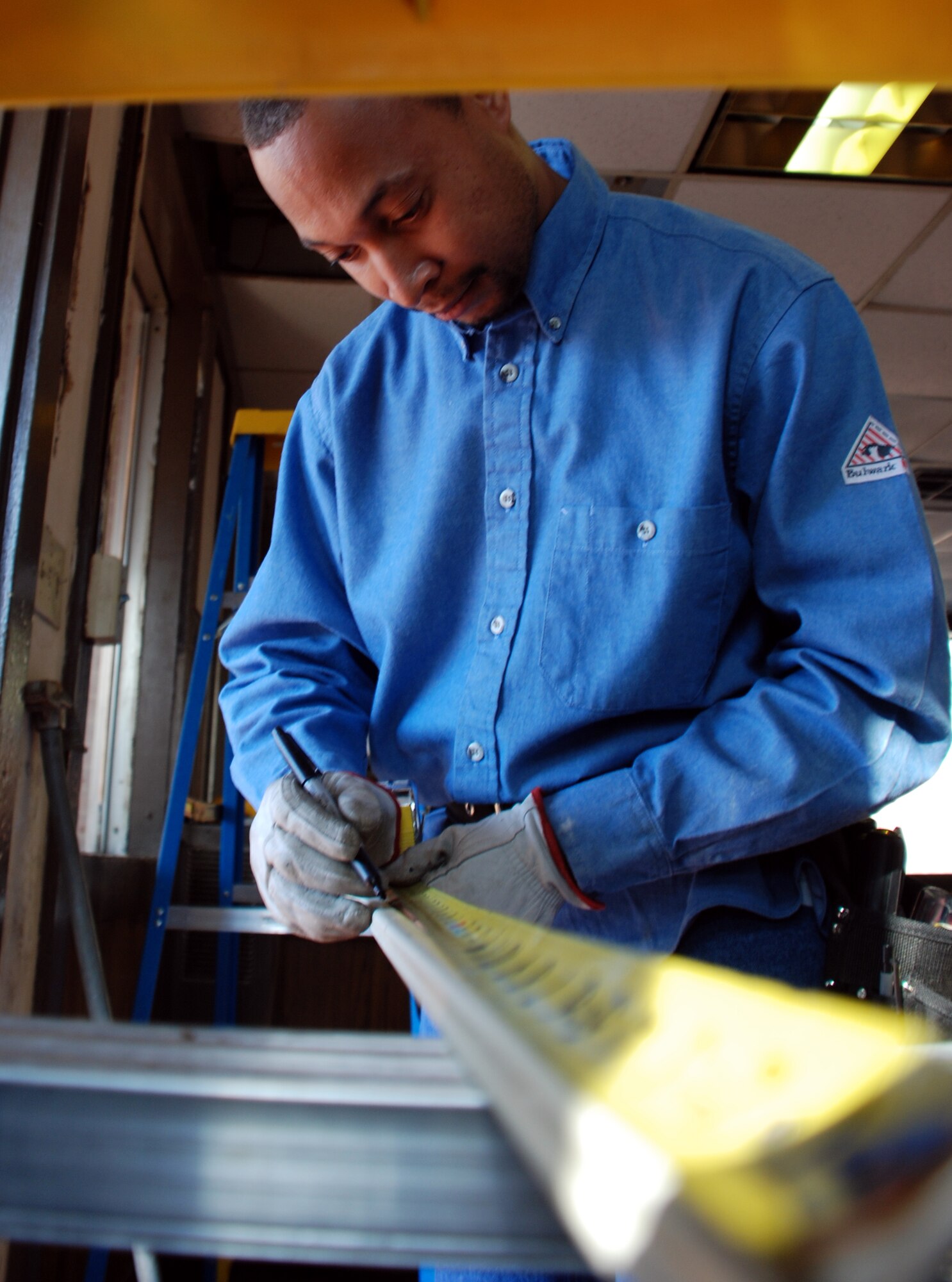 Johnnie Hodges, a civilian electrician with the 82nd Civil Engineer Squadron, measures wiring housing for a new heating system March 15 at the main gate. The heaters will help to keep 82nd Security Forces personnel and augmentees keep warm while on gate-guard duty. (U.S. Air Force photo/Airman 1st Class Jacob Corbin)