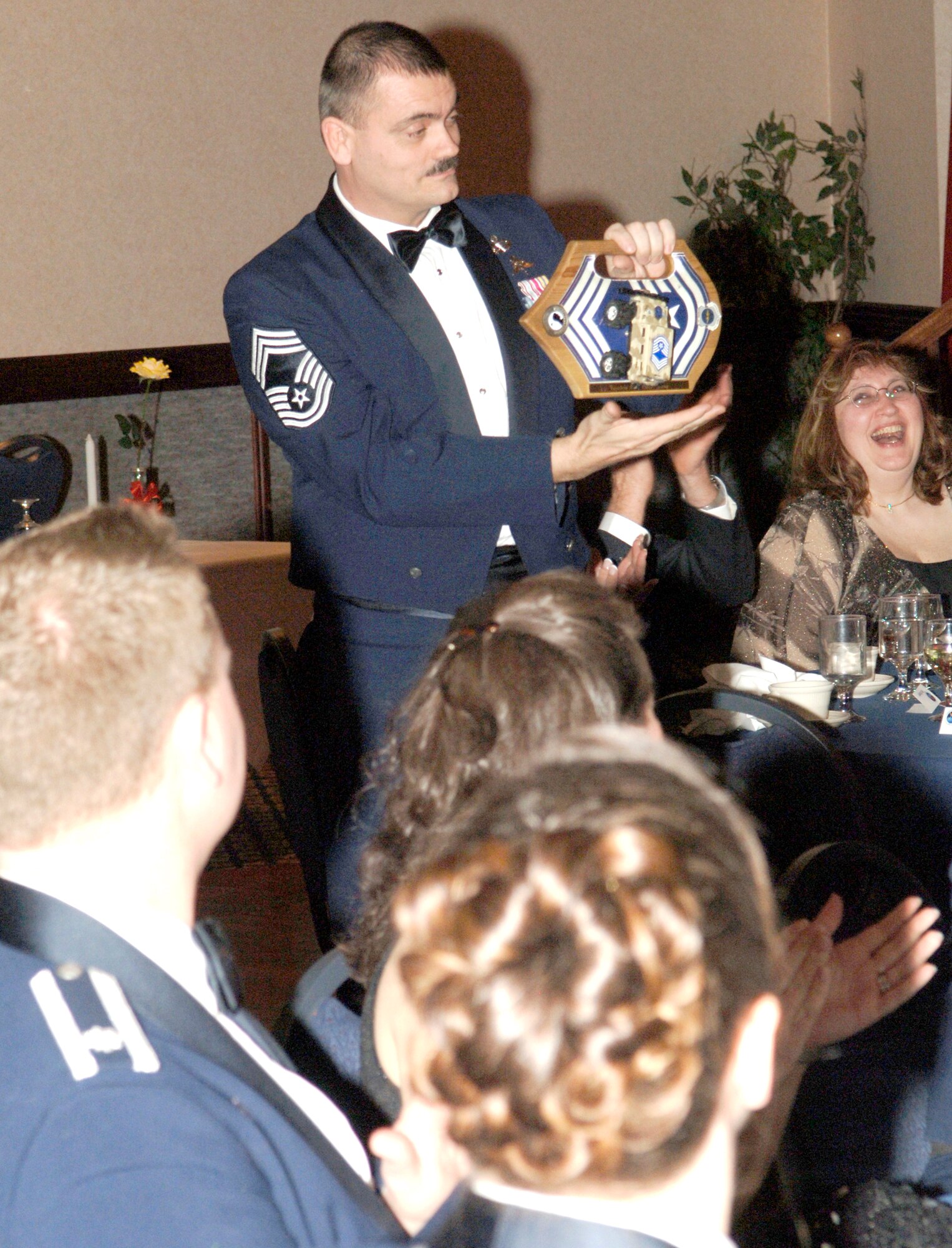 FAIRCHILD AIR FORCE BASE, Wash. -- Chief Master Sgt. Jon Stuhr, 66th Training Squadron chief enlisted manager, accepts his new Jeep Chief title at the Fairchild Chief’s Induction Ceremony, which was held in the Club Fairchild ballroom March 8. According to tradition, the newest chief on a base will carry the Jeep Chief plaque for 30 days after sewing on chief stripes. Chief Stuhr pinned on chief in December and hits 20 years in the Air Force this month. (Photo by Senior Airman Chad Watkins)