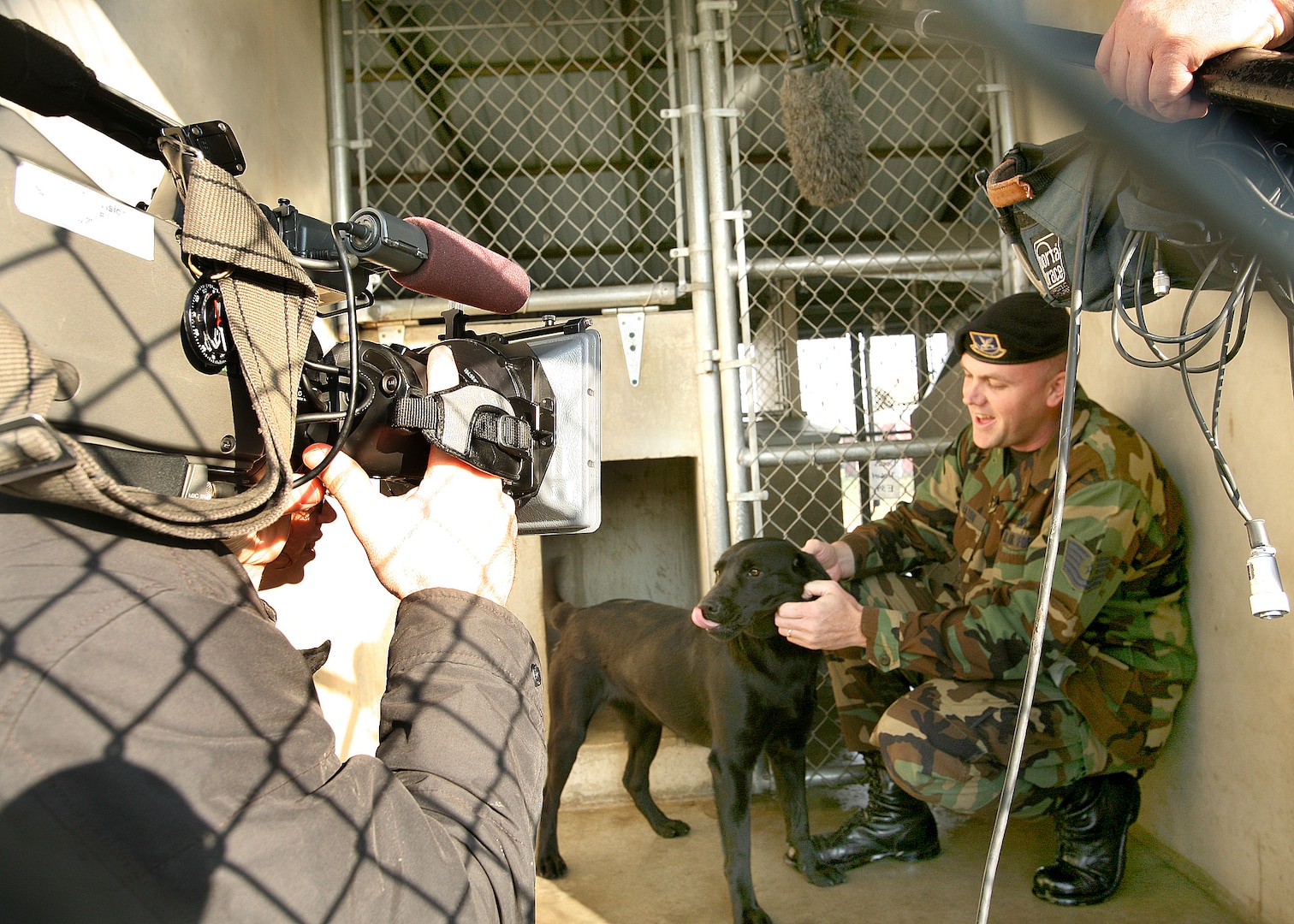 Doris and Tech. Sgt. Jason Eaton, 341st Training Squadron, strike a pose March 12 for a television crew with the Canadian Broadcasting Co. The Lackland Military Working Dog Program, the largest in the world, will be featured in an hourlong documentary into the world and culture of dogs.  The three-person crew, which spent a day and half filming at Lackland Air Force Base, Texas, will also travel to England to film a dog training facility there. The documentary will air this fall. (USAF photo by Robbin Cresswell)
