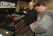 MINOT AIR FORCE BASE, N.D., -- Rod Krause, 5th Bomb Wing ground safety, performs a spot inspection March 13, as Staff Sgt. Brett Whitish, 5th Logistics Readiness Squadron, looks on.  The ground safety office recently garnered the Air Force Chief of Safety Outstanding Achievement Award for Ground Safety. According to Mr. Krause, this award was earned by the all base personnel. (U.S. Air Force photo by Airman 1st Class Christopher Boitz)