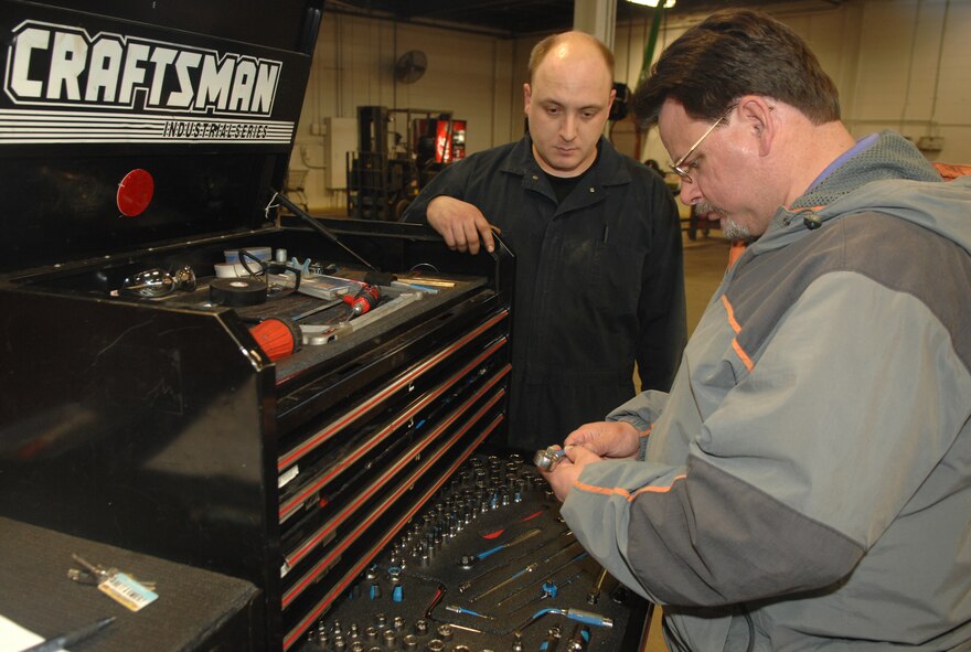 MINOT AIR FORCE BASE, N.D., -- Rod Krause, 5th Bomb Wing ground safety, performs a spot inspection March 13, as Staff Sgt. Brett Whitish, 5th Logistics Readiness Squadron, looks on.  The ground safety office recently garnered the Air Force Chief of Safety Outstanding Achievement Award for Ground Safety. According to Mr. Krause, this award was earned by the all base personnel. (U.S. Air Force photo by Airman 1st Class Christopher Boitz)