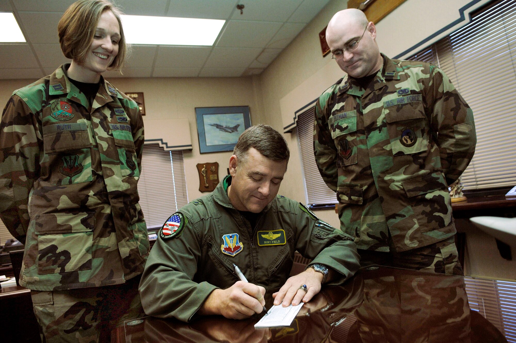 Brig. Gen. Burton Field, 1st Fighter Wing commander, fills out an Air Force Assistance Fund donation slip Feb. 28 for Capt. Kylene Ruth and 1st Lt. Joel Pitman, 1st FW Air Force Assistance Fund representatives. 

The campaign, which  runs until April 15, consists of four charities:  The General and Mrs. LeMay Foundation; the Air Force Enlisted Village Inc.; the Air Force Village Foundation and the Air Force Aid Society. Because the program directly benefits servicemembers here, Langley Airmen are encouraged to donate. By contributing to the fund, Airmen not only help other Airmen, but may also potentially help themselves. For more information or to donate, people can contact their unit project officers or supervisors. (U.S. Air Force photo/Staff Sgt. Samuel Rogers)
