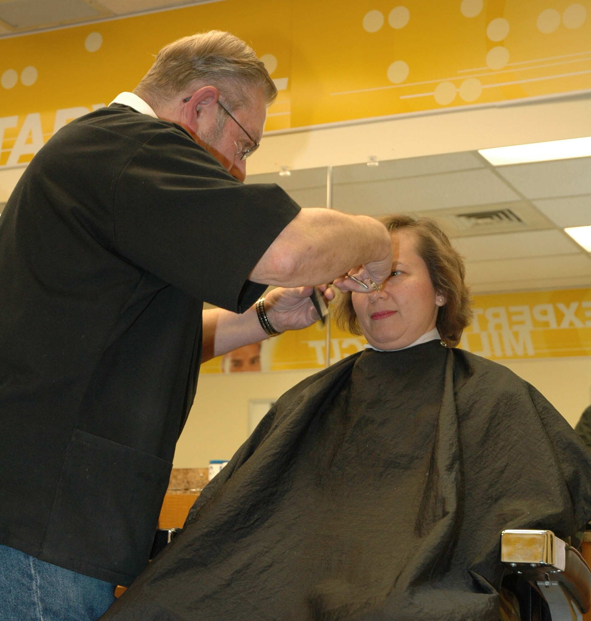 AAFES veteran barber Jim Thul takes the scissors to 341st Space Wing Commander Sandy Finan's hair Feb. 27 keeping his long-standing tradition of cutting the commander's hair intact. He's been a barber at Malmstrom since 1959.