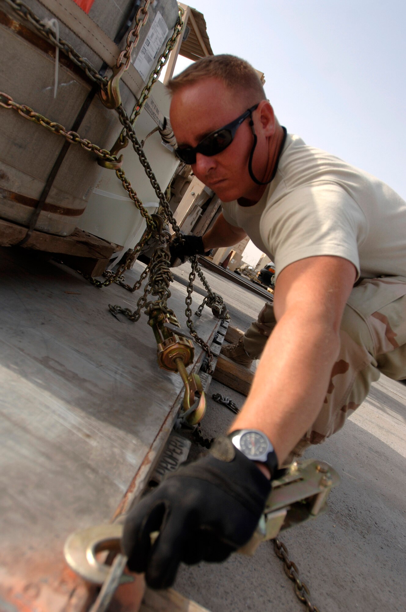 Staff Sgt. Todd Frederick secures military gear onto a pallet. He and other aerial porters load approximately 2.1 million pounds of cargo per week in Southwest Asia. The aerial porter's current mission supports, Operation Achilles, a campaign to create a secure environment and better quality of life for Afghan citizens. Sergeant Frederick is assigned to the 8th Expeditionary Air Mobility Squadron. (U.S. Air Force photo/Tech. Sgt. Cecilio Ricardo Jr.)