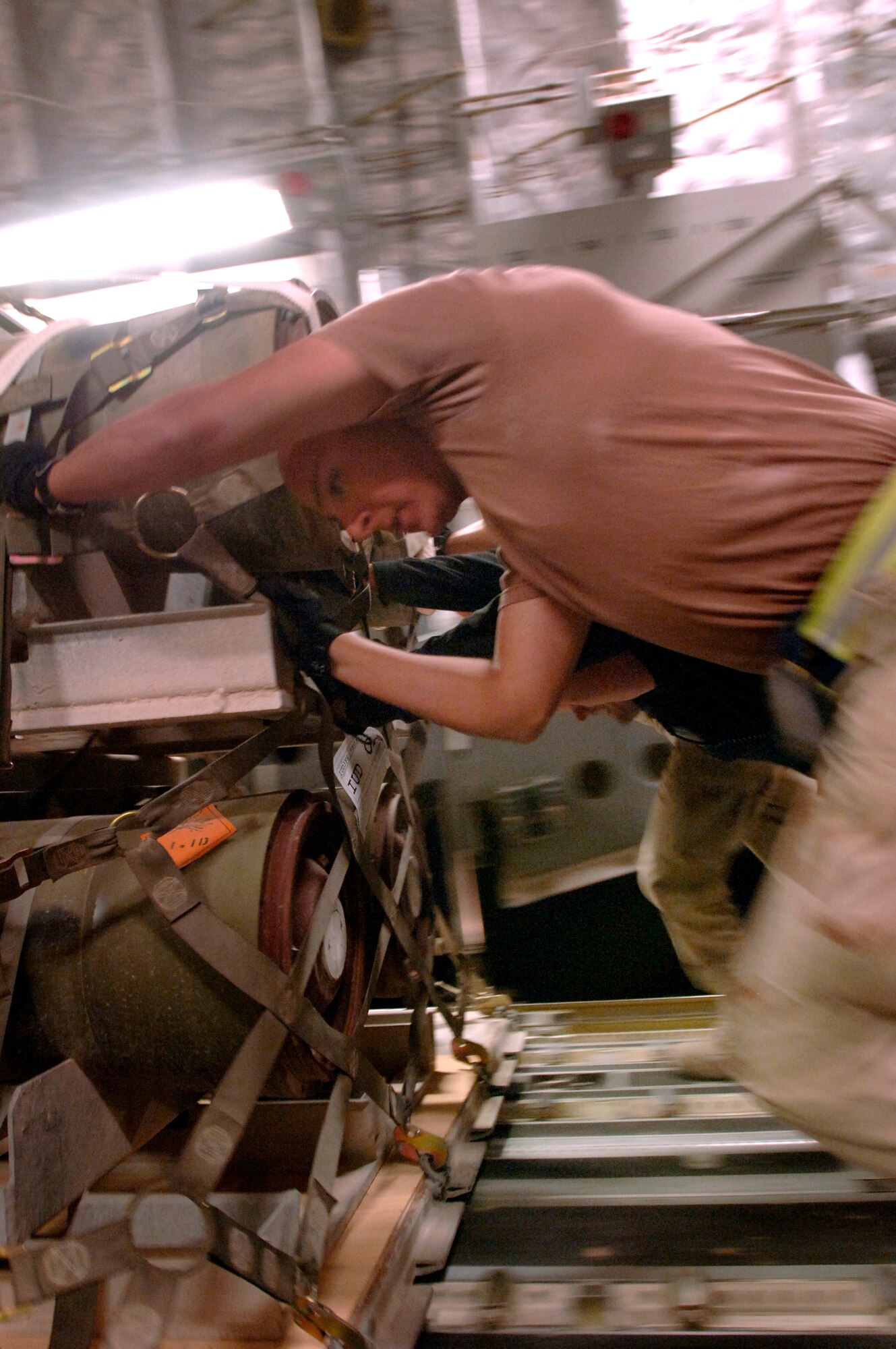 Airman 1st Class Arnold Pena, along with his crew of aerial porters, loads a pallet of bombs onto a C-17 Globemaster III. Approximately 2.1 million pounds of cargo are loaded per week. The Airmen are supporting, Operation Achilles, a campaign to create a secure environment and better quality of life for Afghan citizens. The aerial porters are assigned to the 8th Expeditionary Air Mobility Squadro in Southwest Asia. (U.S. Air Force photo/Tech. Sgt. Cecilio Ricardo Jr.)

