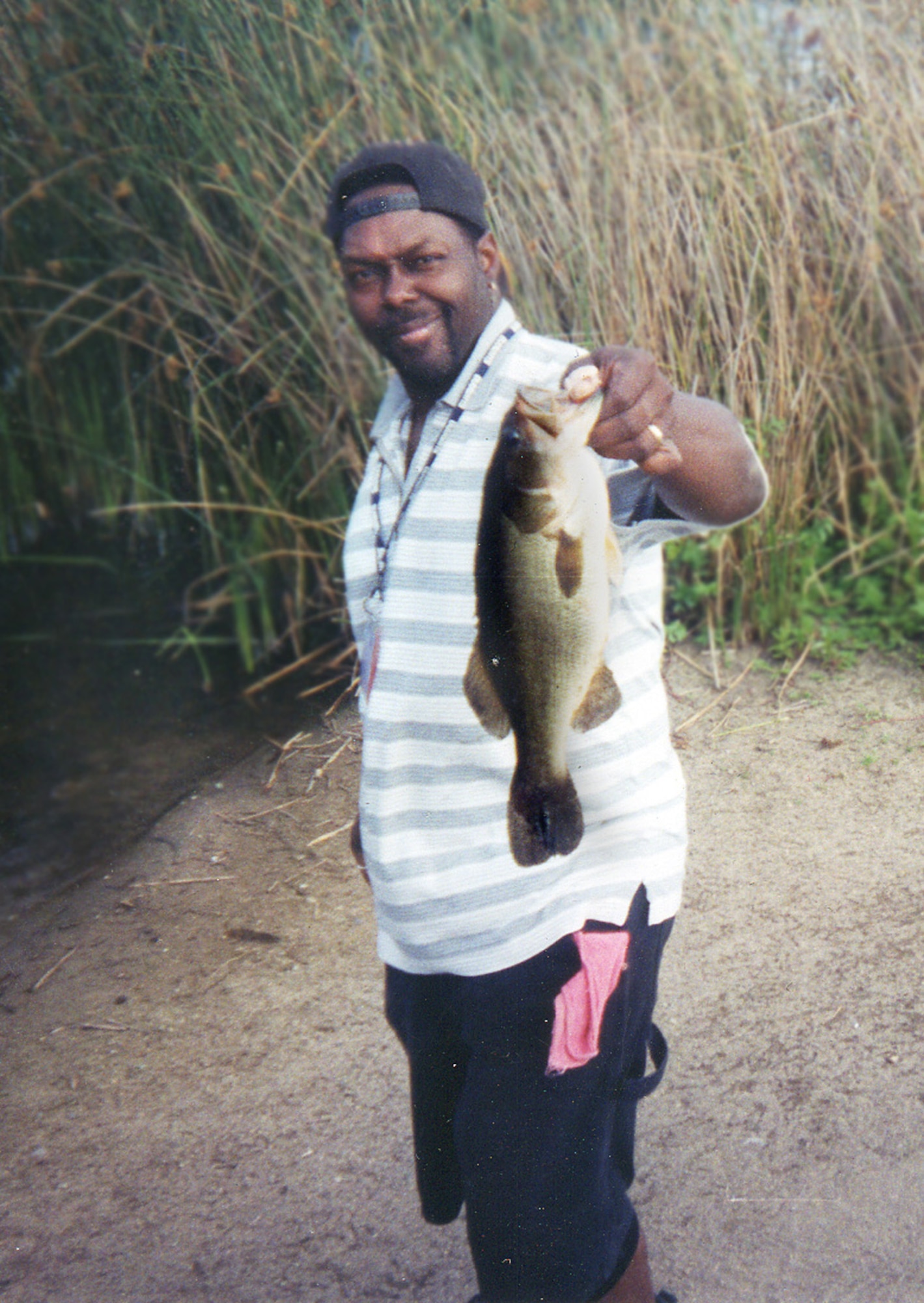 Eddie Kidd, a 100th Services Squadron school-age programs coordinator, holds up the 4-pound bass he caught in Marina, Calif., in April 2006. The biggest bass Mr. Kidd ever caught weighed 13.75 pounds -- more than three times the size of the fish shown here. Mr Kidd is competing in two Bassmaster Western Elite Series competitions in California -- the Duel in the Delta, March 22 to 25, followed by the Golden State Shootout, March 29 to April 1. The competitions are for the top professionals and co-anglers of the Bassmasters Division. The heaviest fish he ever caught was a 155-pound catfish, in July 2000.