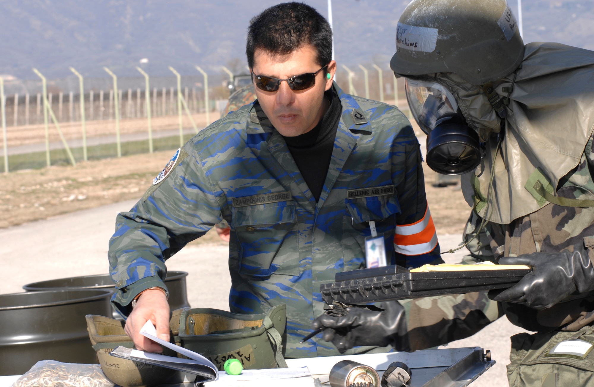 Second Lt. George Zampounis, NATO evaluator,  left, reviews operations with Tech. Sgt. Royce Hutchins, 31st Maintenance Squadron, during the Tactical Evaluation  here. The evaulation was to ensure Aviano Airmen are combat ready. (U.S. Air Force photo by Airman 1st Class  Liliana Moreno)