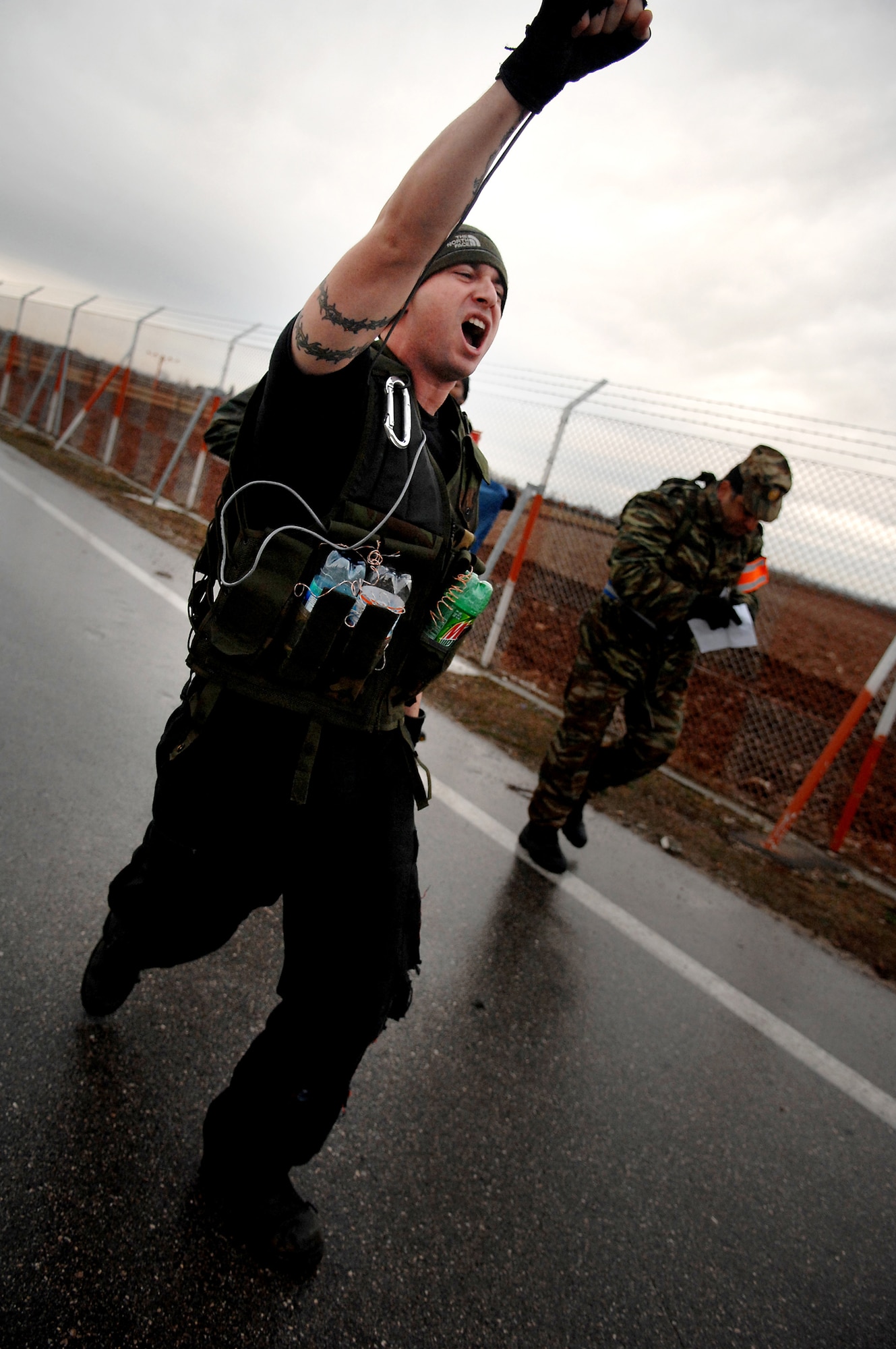 A protestor with a mock bomb strapped to his body makes his way to the Entry Control Point during the NATO Tactical Evaluation here March 7.  Protestors were used to test the response of the 31st Security Forces Squadron. (U.S. Air Force photo by Staff Sgt. Bethann Caporaletti)