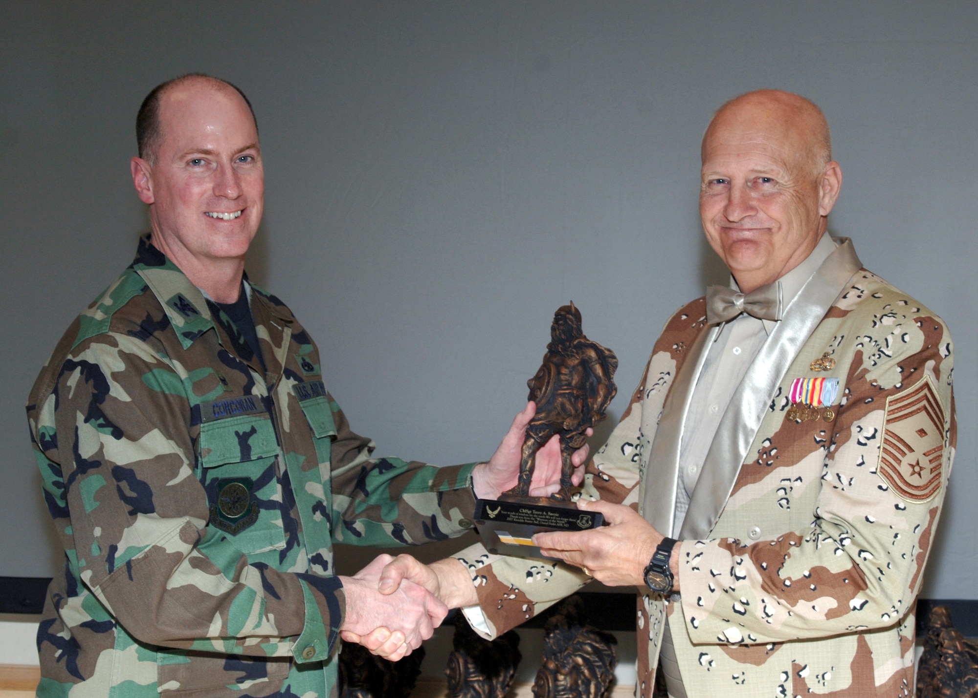 GRAND FORKS AIR FORCE BASE, N.D. – Col. Raymond Corcoran, 319th Maintenance Group commander, gives Chief Master Sgt. (Ret.) Terry Savoie a “Sven”, the wing’s mascot, during the group’s Knucklebuster Annual Awards Banquet here GRAND FORKS AIR FORCE BASE, N.D. – ProSuperman delivers the awards list during the 319th Maintenance Group Annual Awards Banquet here (U.S. Air Force photo/Staff Sgt. Suellyn Nuckolls). 

