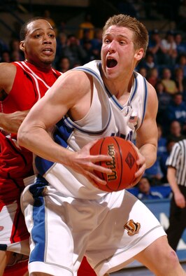 Air Force forward Jacob Burtschi is defended by Austin Peay forward Fernandez Lockett in the first-round game of the National Invitation Tournament at the Air Force Academy's Clune Arena March 14. All five Falcon starters, including Burschi, scored 13 points in their 75-51 win over the Governors in Air Force's first post-season victory in school history. (U.S. Air Force photo/1st Lt. John Ross)
