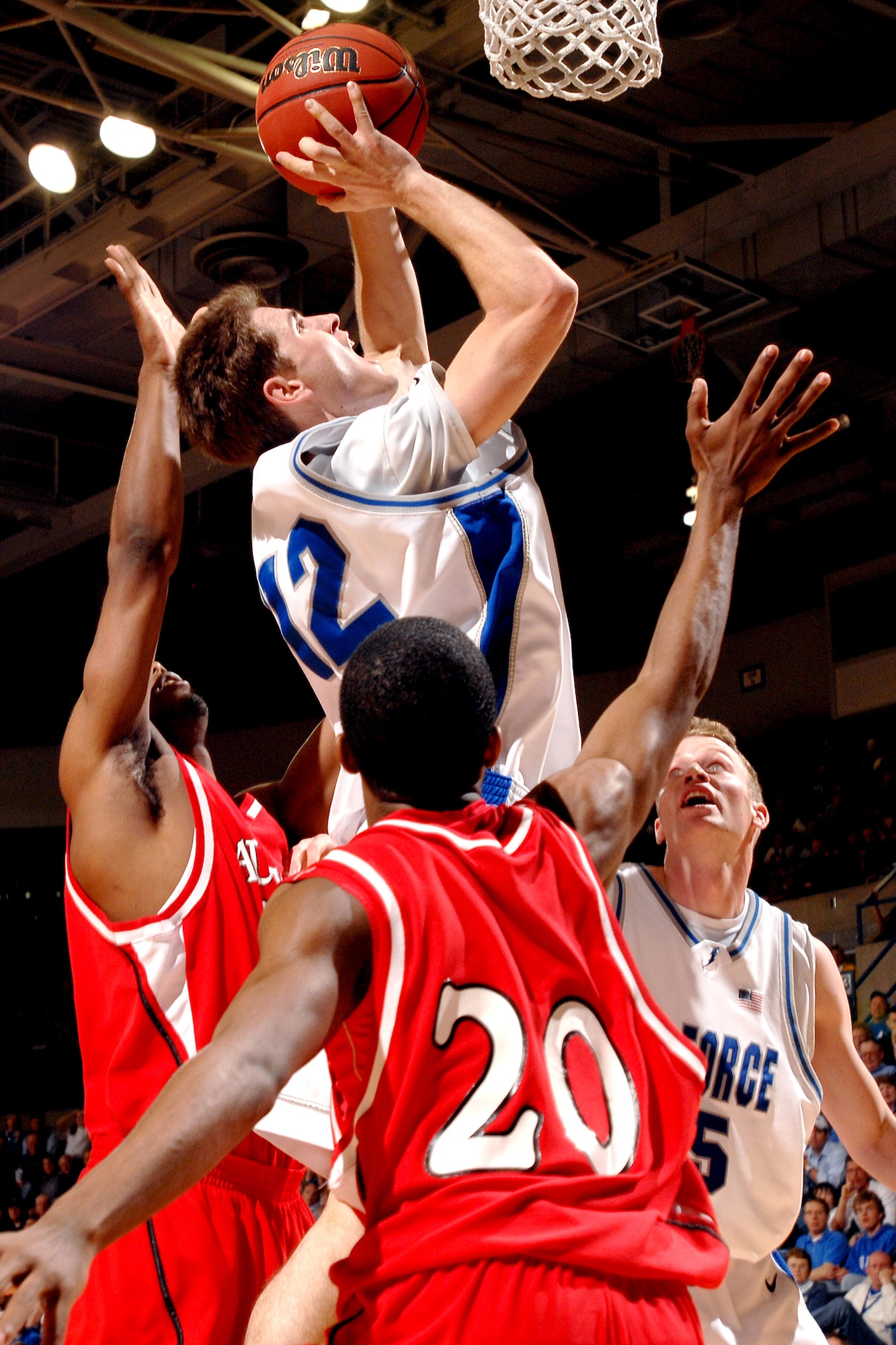 Air Force guard Tim Anderson elevates himself above Austin Peay defender Derek Wright for a lay up at the Air Force Academy's Clune Arena in Colorado Springs, Colo., March 14. By defeating Austin Peay 75-51 in the first round of the National Invitation Tournament, Air Force has its first post-season win in school history. (U.S. Air Force photo/Danny Meyer)
