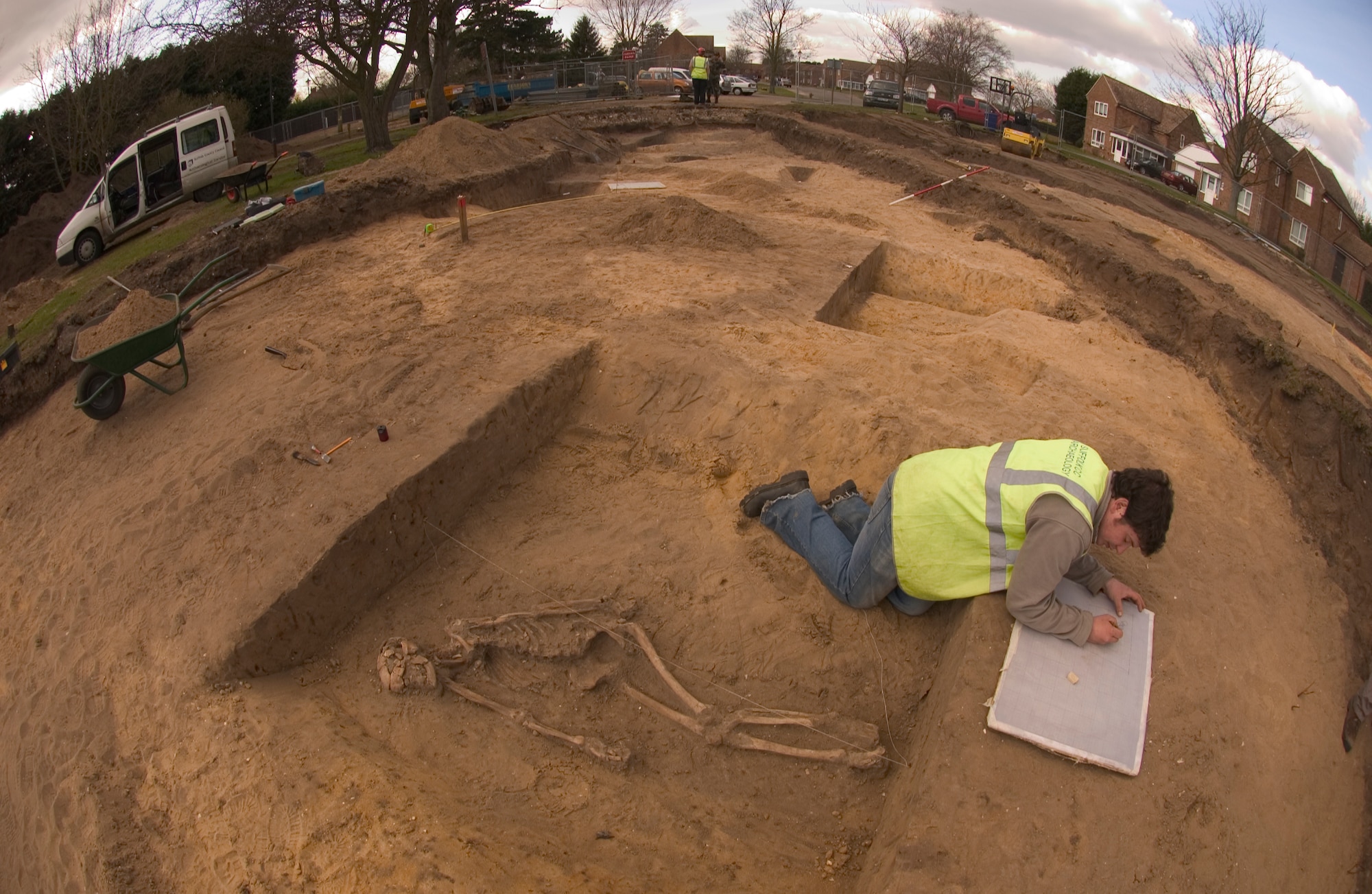 After discovering a human skeleton Monday, March 12, John Sims, an archeologist for Suffolk County Council, England, sketches the remains March 14 prior to removing the bones for further study at the company's home office. The skeleton was found during an excavation of land nearby RAF Mildenhall where new housing is planned. (Air Force photo by Tech. Sgt. Tracy L. DeMarco)
