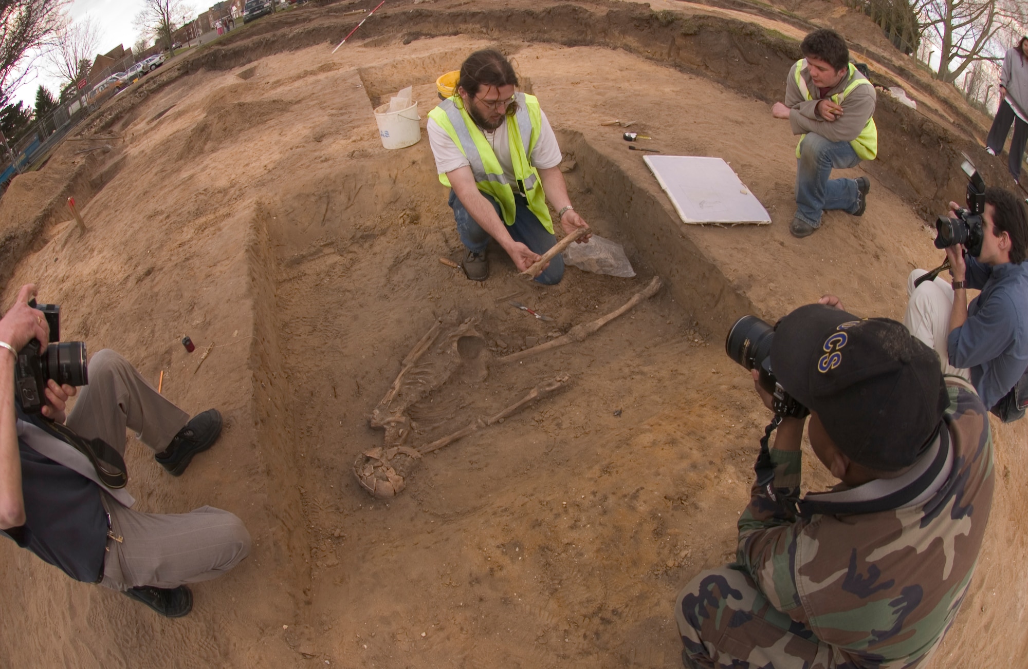 John Craven, an archeologist for Suffolk County, lifts the remains of a human skeleton from the earth March 14, for further study at the company's home office. The skeleton was found about a half meter below the original ground during an excavation of land in RAF Mildenhall's Beck Row base housing where new construction is starting. It was estimated on site to be of 1st Century AD. Roman descent between 1,900 to 2,000 years old. (Air Force photo by Tech. Sgt. Tracy L. DeMarco)
