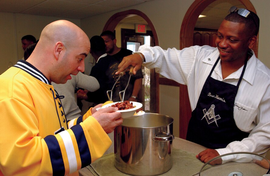 KUNSAN AIR BASE, Republic of Korea April 14, 2006 -- Former 8th Operations Group first sergeant Jeffrey Lizak gets served a helping of corn at the Sonlight Inn April 14, 2006. Various organizations from across base cook meals every Friday night as part of the chapel's overall Airmen morale and welfare program. Friday night meals are traditional served at 6 p.m. and are one of many programs that helped the chapel win the 'PACAF 2006 Small Base Chapel Organization Award.' (Air Force photo/Staff Sgt. Josef Cole III)
