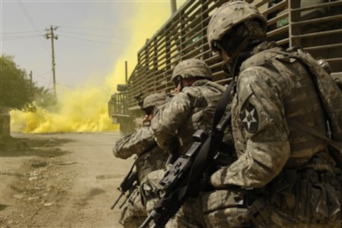 U.S. Army soldiers from the 1st Stryker Brigade Combat Team use smoke grenades for concealment as they engage anti-Iraqi forces in Buhriz, Iraq, on March 14, 2007.   Soldiers from the 5th Battalion, 3rd Brigade, 2nd Infantry Division are conducting their first mission in the Diyala province.  