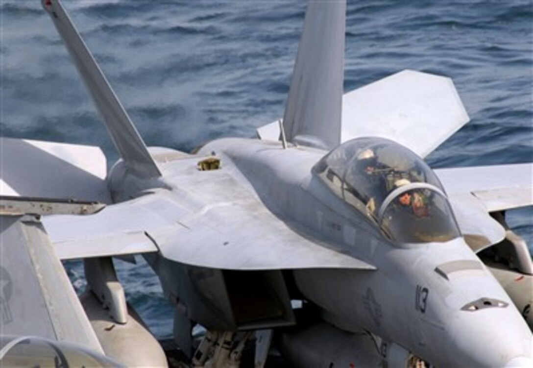 Pilots assigned to the "Black Knights" of Strike Fighter Squadron 154 test their F/A-18F Super Hornet's ailerons prior to launch aboard Nimitz-class aircraft carrier USS John C. Stennis in the Arabian Sea, March 13, 2007. 