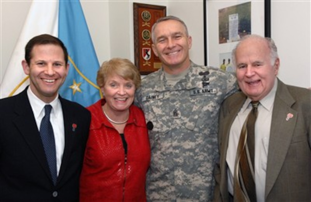 Dan Turner, a representative from DuPont; Jeanette Cram, founder of Treat the Troops; U.S. Army Sgt. Maj. William J. Gainey, senior enlisted advisor to the chairman of the Joint Chiefs of Staff; and Jack Cram, pose for a photo in Gainey’s office at the Pentagon, March 15, 2007. 