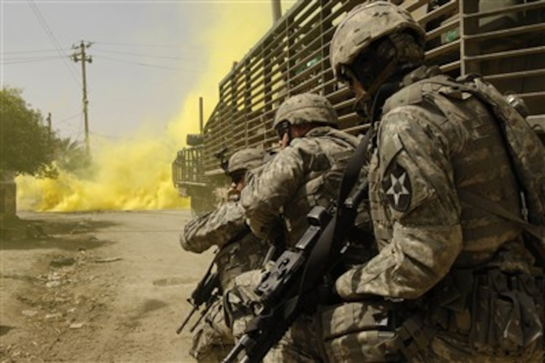 U.S. Army soldiers use smoke grenades for concealment.