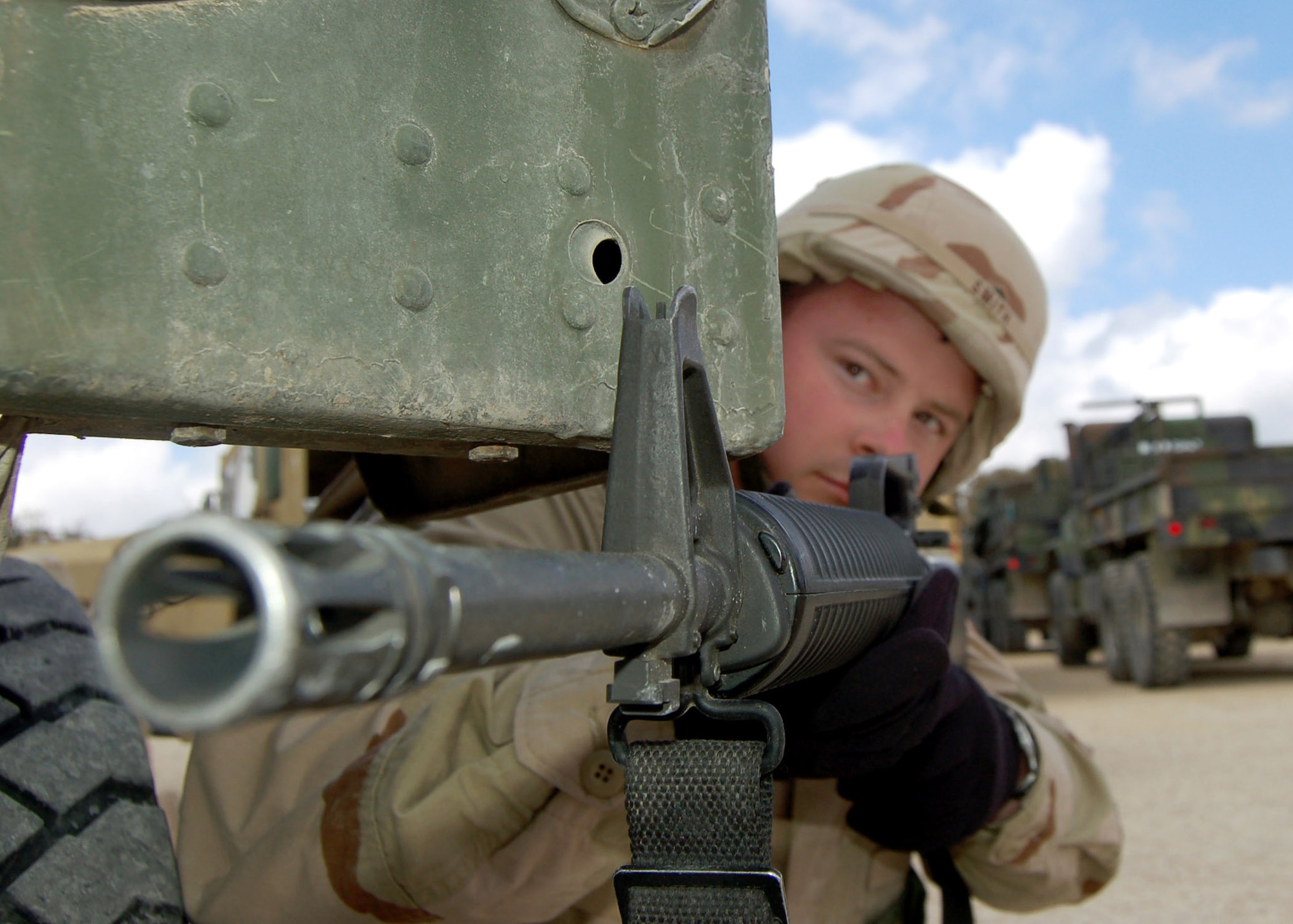 Tech. Sgt. Charles Smith stares down the barrel of his gun as he guards a simulated convoy mission. Sergeant Smith is a student in the specialized mission course at Camp Bullis, Texas. The two week course is the students first step in a mission that will help the Iraqi air force rebuild their technical schools. (U.S. Air Force photo/ Airman 1st Class Robbie Arp)