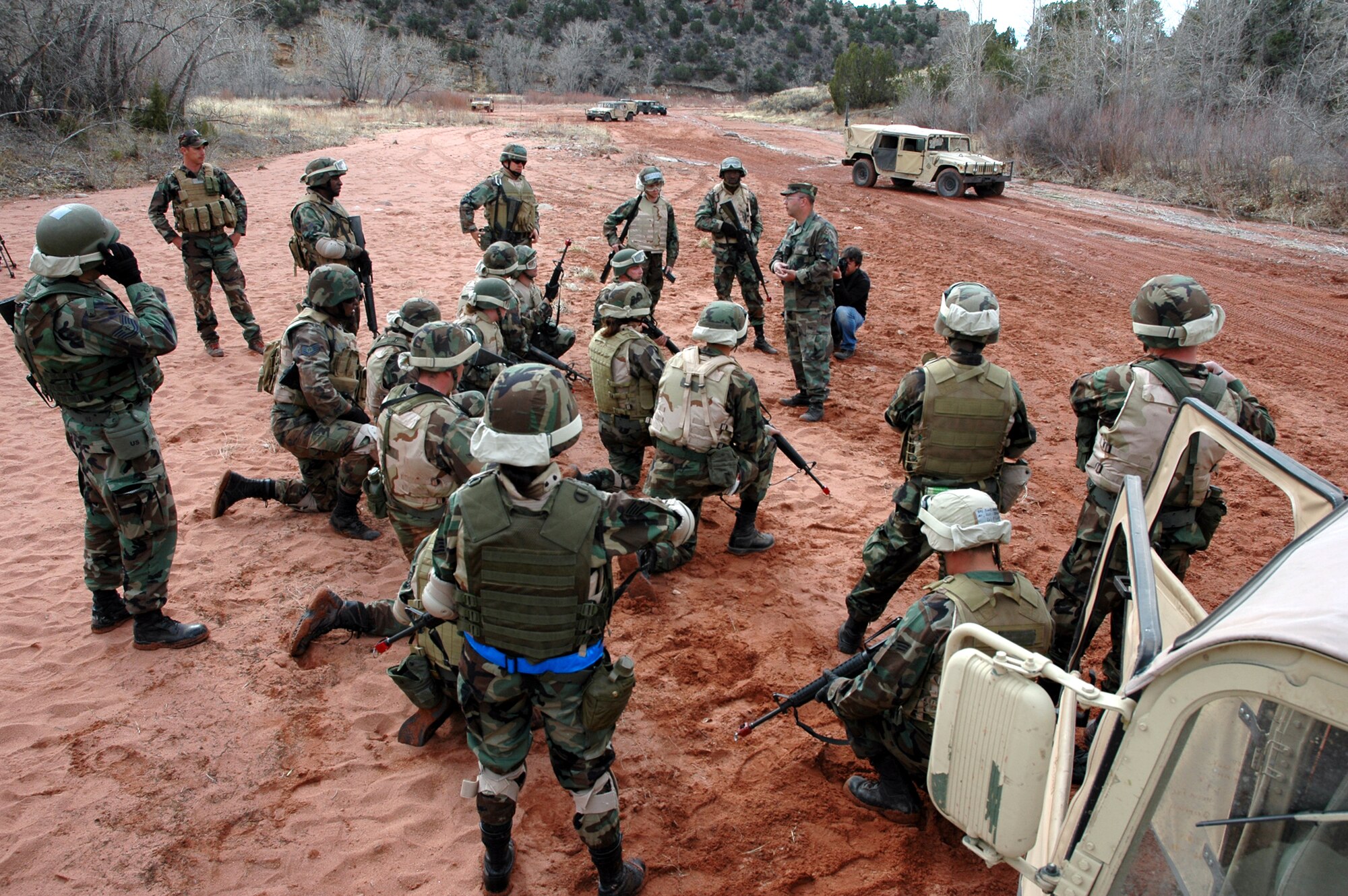The Airmen gather in a dry creek bed following the ambush, for tips on how to improve their reactions. (U.S. Air Force photo by Steve Brady)