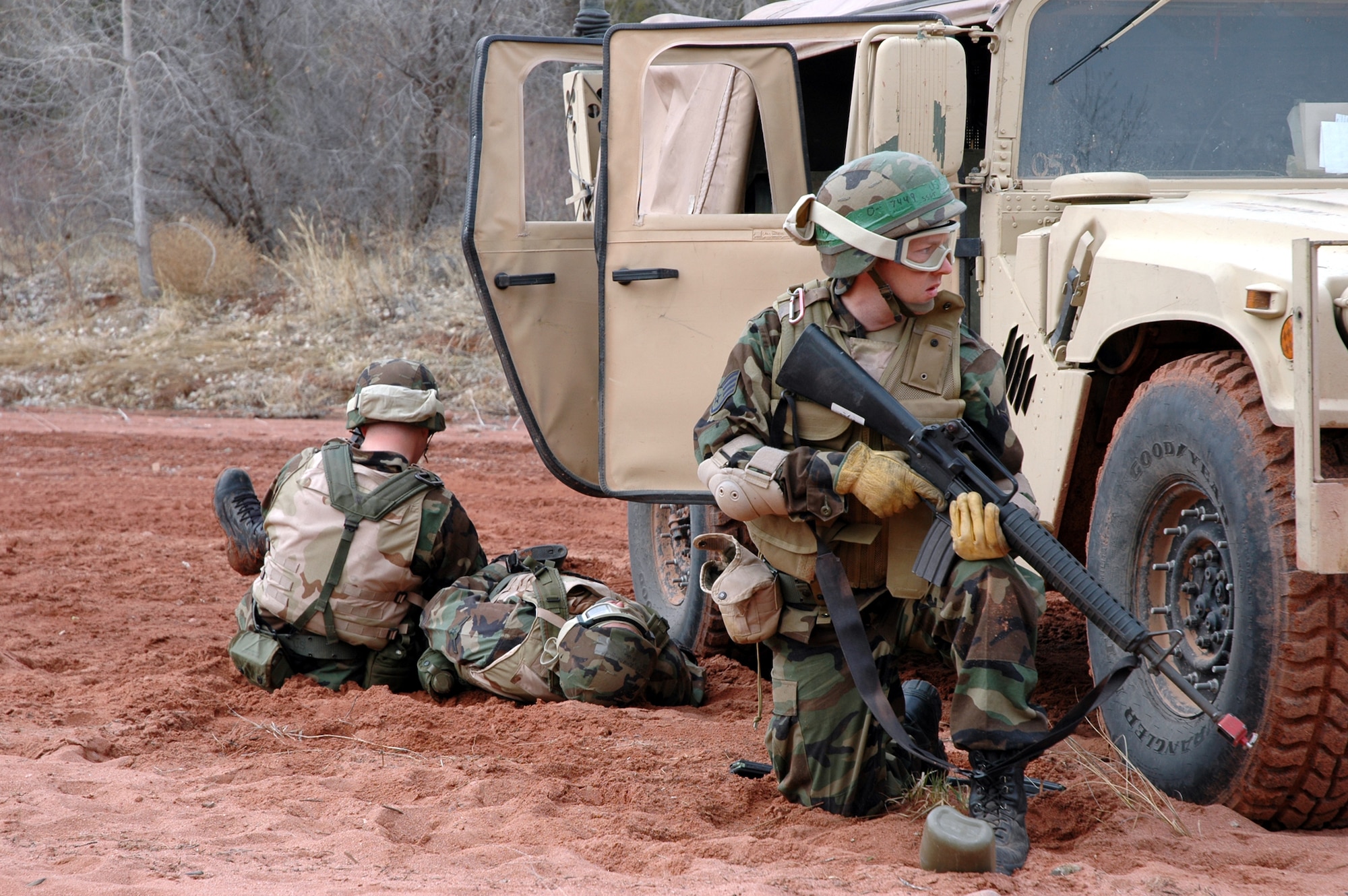 Staff Sgt. Jason Casebolt, an electrical power productions craftsman with the 21st Civil Engineer Battalion, provides cover as one of his Warrior Airmen administers aid to a “wounded” Airman. The convoy training exercise was part of Exercise Red Devil at Fort Carson. (U.S. Air Force photo by Steve Brady)