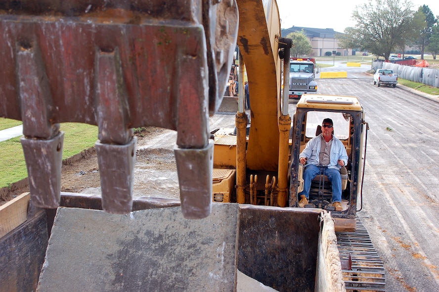 MOODY AIR FORCE BASE, Ga, -- Greg Gouge, equipment operator for Reames and Son Construction, dumps a load of broken concrete into a dump truck March 15 in front of the Consolidated Base Support Center currently being constructed at Moody.  Antiterrorism and security requirements call for the removal of the roads that once ran past the front of the site. (U.S. Air Force photo by Tech. Sgt. Parker Gyokeres) 