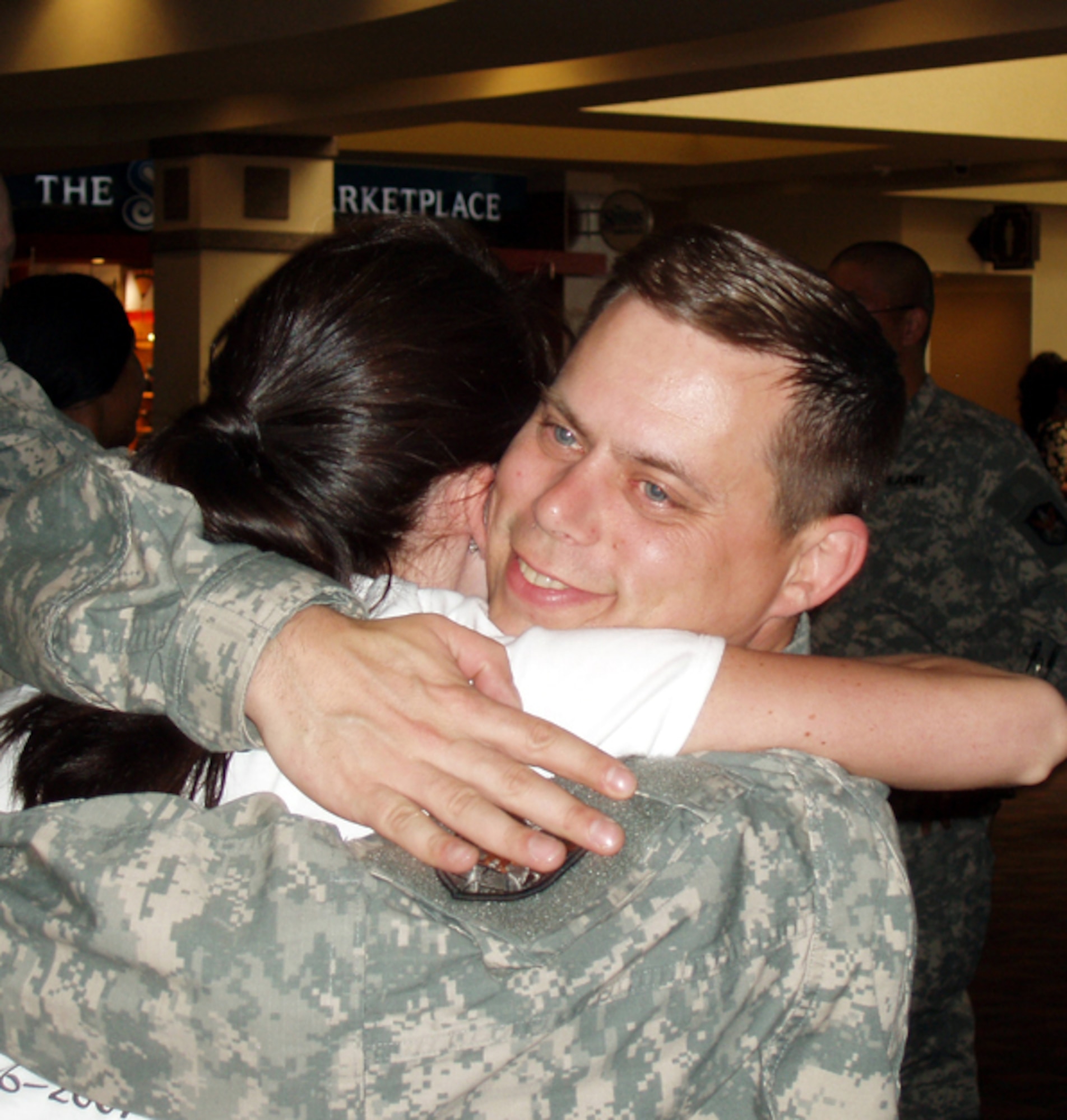 Capt. John Yungbluth gets a welcome home hug upon his return from a tour of duty supporting Operation Iraqi Freedom. The Commercial Exploitation Team is one of several units from U.S. Army Space and Missile Defense Command/U.S. Army Forces Strategic Command currently supporting operations in the Middle East. (U.S. Army photo)