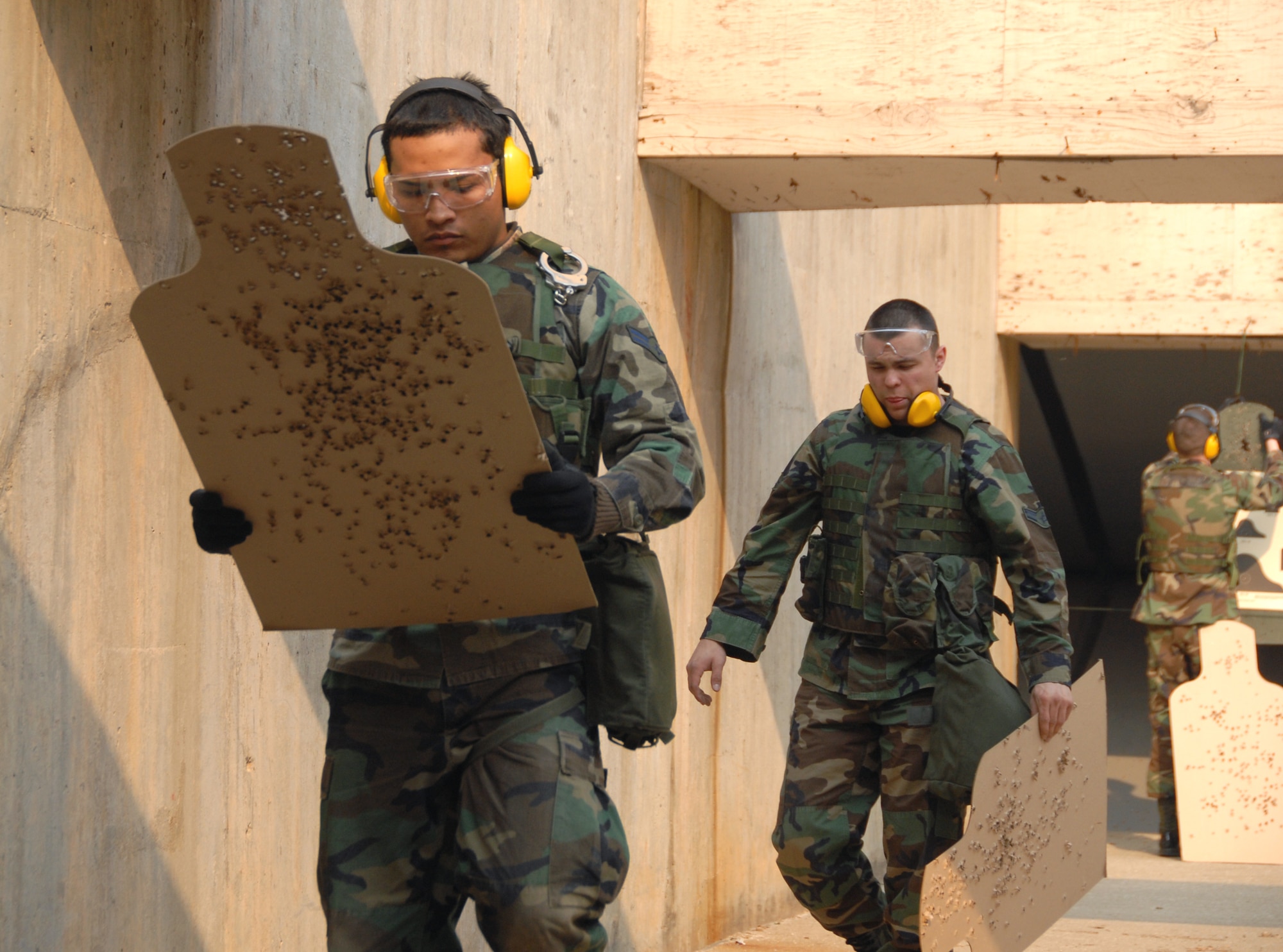 An Airman checks his target after firing at the at the Osan Air Base, South Korea, shooting range March 15.  (U.S. Air Force photo/Airman 1st Class Chad Strohmeyer).