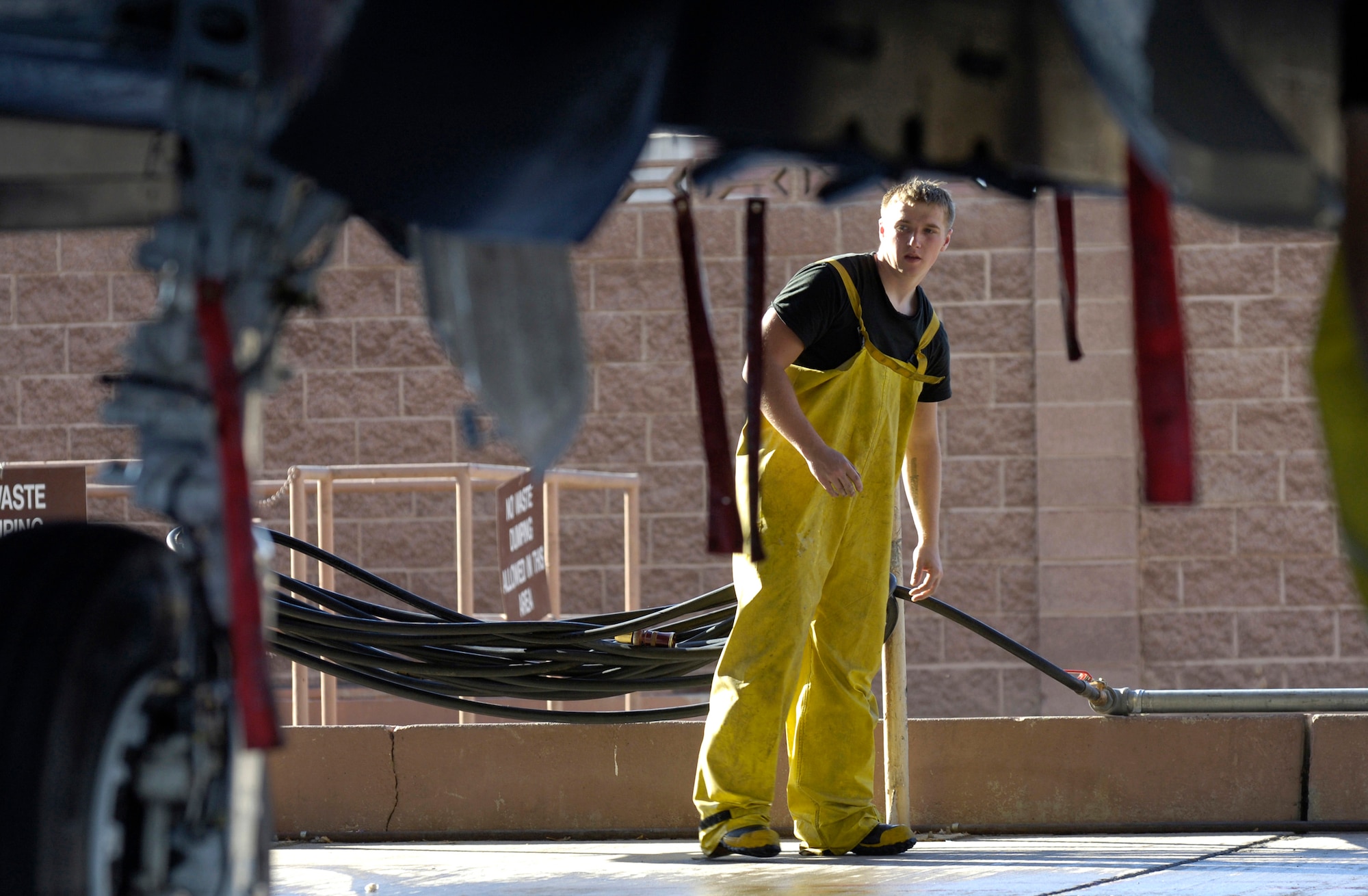 Airman 1st Class Dylan Edson takes one final look after washing an F-15E Strike Eagle during a 120-day periodic cleaning March 15 at Nellis Air Force Base, Nev.  Airman Edson is an avionics specialist assigned to the 57th Aircraft Maintenance Squadron at Nellis.  (U.S. Air Force photo/Master Sgt. Kevin J. Gruenwald)