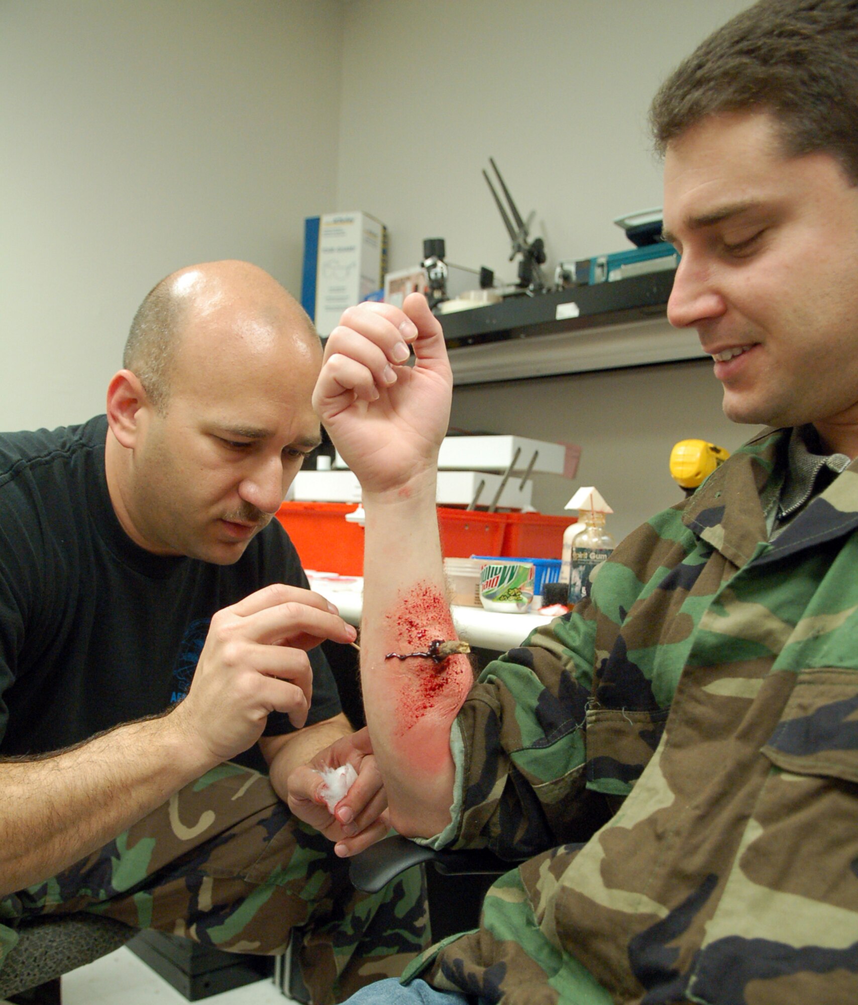 LAUGHLIN AIR FORCE BASE, Texas -- Capt. John Weaver, 47th Medical Group readiness officer, details a faux injury involving a stick through the arm of 2nd Lt. Alan Hale.  (U.S. Air Force photo by Staff Sgt. Austin M. May)