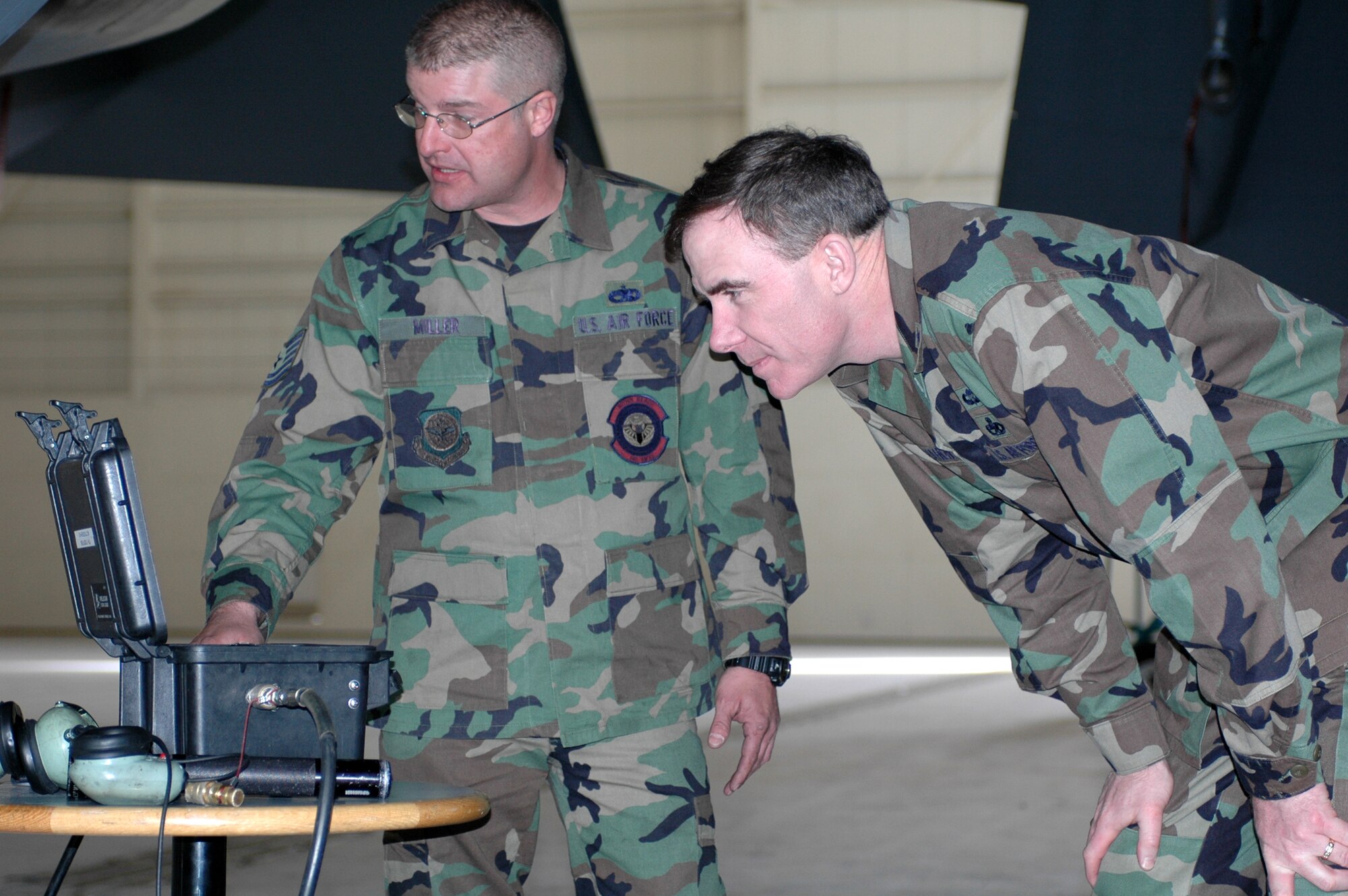 Brig. Gen. Robert McMahon, Director of Logistics, Headquarters Air Mobility Command, Scott Air Force Base, Ill. looks over a presentation given by Tech. Sgt. Randall Miller, 660th Aircraft Maintenance Squadron shop lead technician. Sergeant Miller briefed General McMahon about a KC-10 thrust reverser tester demonstration during the general's visit March 9. (U.S. Air Force photo by Airman Kristen Rohrer)