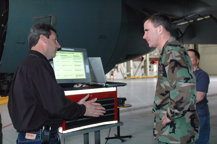 Mr. Jeff Hammett, General Electric field service representative, gives a briefing about a KC-10 thrust reverser tester demonstration to Brig. Gen. Robert McMahon, Director of Logistics, Headquarters Air Mobility Command, Scott Air Force Base, Ill., during the general's visit March 9. (U.S. Air Force photo by Airman Kristen Rohrer)