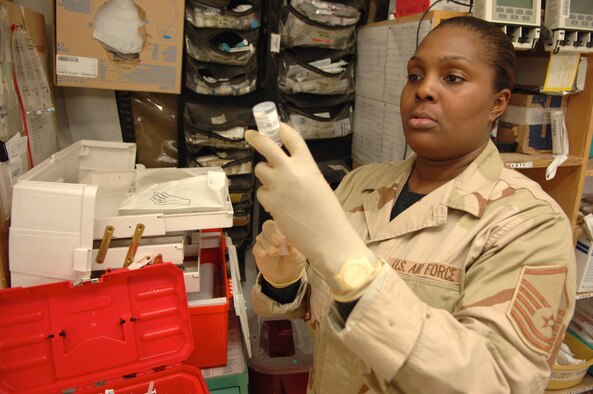 BALAD AIR BASE, Iraq -- Master Sgt. Michelle Bloxson prepares a hypodermic needle to draw antibiotics for an incoming trauma patient in the Air Force theater hospital emergency room here. Sgt. Bloxson is the noncommissioned officer in charge of the pharmacy flight with the 332nd Air Expeditionary Wing's 332nd Expeditionary Medical Group. She is deployed from Wright-Patterson Air Force Base, Ohio. (Air Force photo by Staff Sgt. Michael R. Holzworth) 