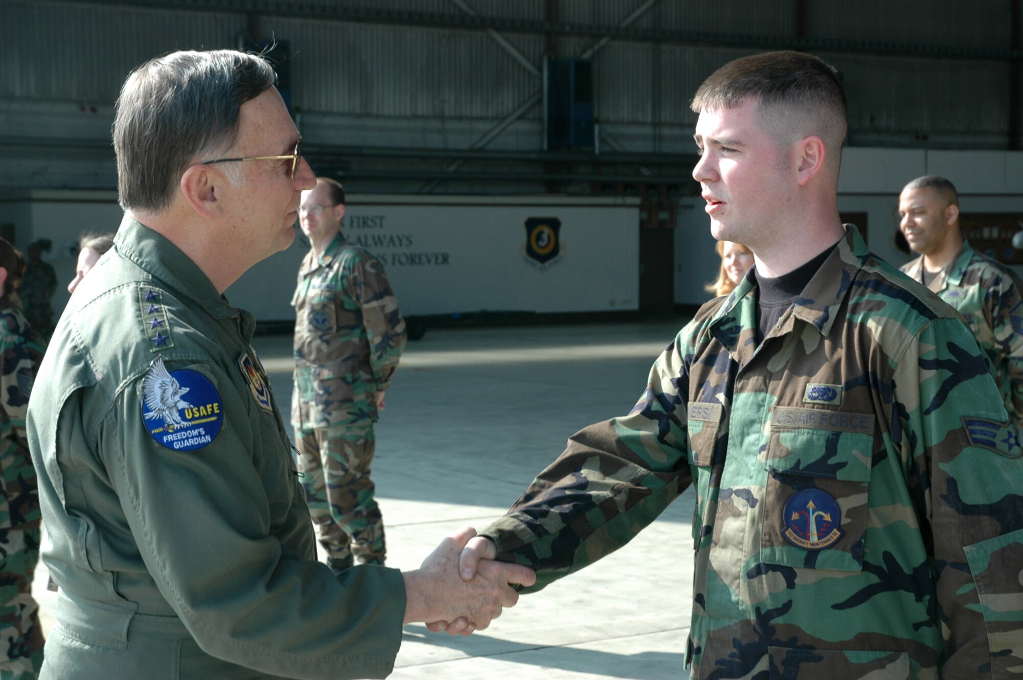 SPANGDAHLEM AIR BASE, Germany -- Gen. Tom Hobbins, U.S. Air Forces in Europe commander, meets Senior Airman Ryan Conversi, 52nd Aircraft Maintenance Squadron, while at Spangdahlem Air Base to shoot an American Forces Network commercial here March 15.