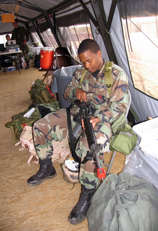 Senior Airman Keenan Gunter, 66th Comptroller Squadron, performs a function check on his M-16A2 rifle at a “deployed” location March 14 during the Hanscom Base Readiness Inspection. (US Air Force Photo by 1st Lt Lisa Spilinek)

